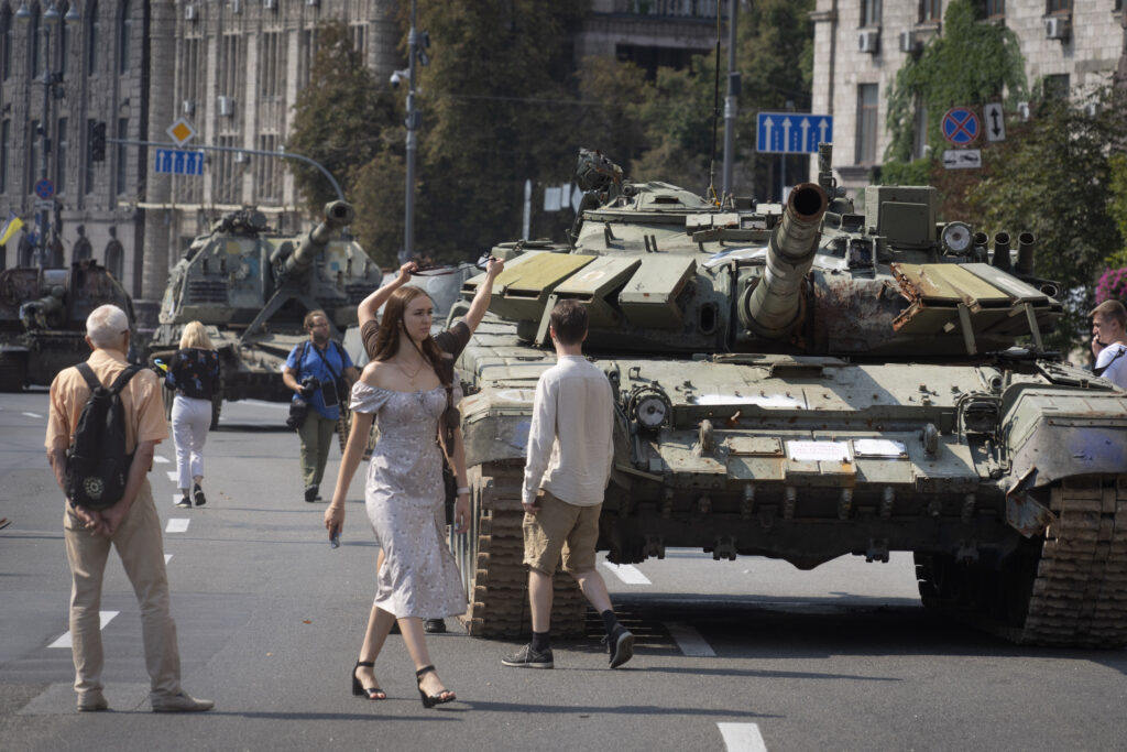 People visit an avenue where destroyed Russian military vehicles have been displayed ahead of the Independence Day in Kyiv, Ukraine, Monday, Aug. 21, 2023. Ukraine marks the Independence Day on Aug. 24. (AP Photo/Efrem Lukatsky)