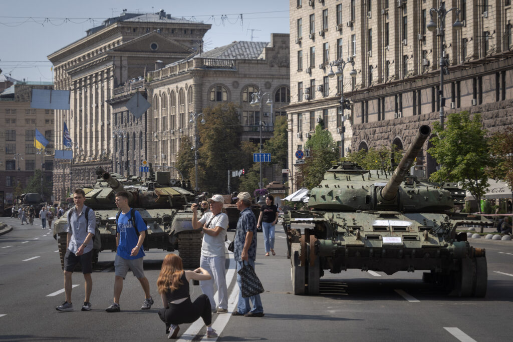 People visit an avenue where destroyed Russian military vehicles have been displayed ahead of the Independence Day in Kyiv, Ukraine, Monday, Aug. 21, 2023. Ukraine marks the Independence Day on Aug. 24. (AP Photo/Efrem Lukatsky)