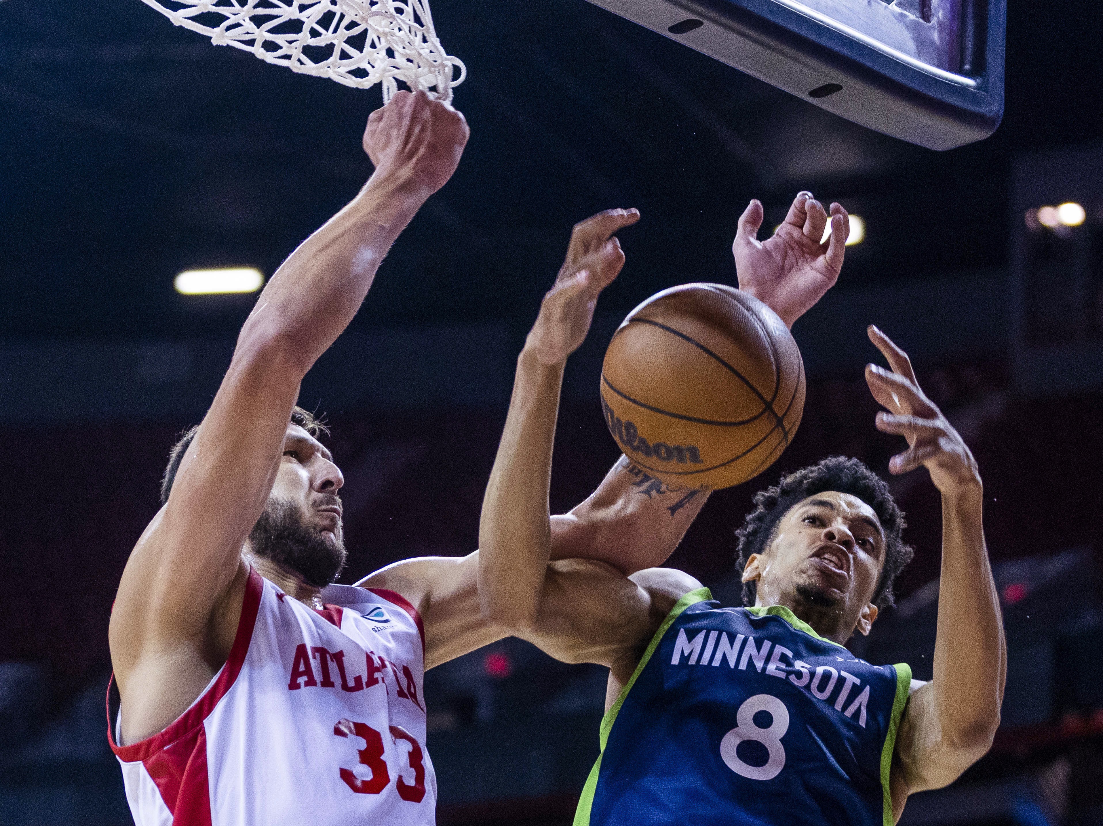 Atlanta Hawks forward Uros Plavsic (33) and Minnesota Timberwolves forward Josh Minott (8) vie for the ball during the first half of an NBA summer league basketball game Wednesday, July 12, 2023, in Las Vegas. (L.E. Baskow/Las Vegas Review-Journal via AP)
