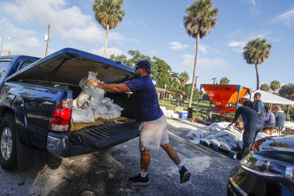 CORRECTS BYLINE David Fuentes, 34, loads sandbags onto a truck bed, ahead of Tropical Storm Idalia's arrival, at MacFarlane Park in Tampa on Monday, Aug. 28, 2023. (Ivy Ceballo/Tampa Bay Times via AP)