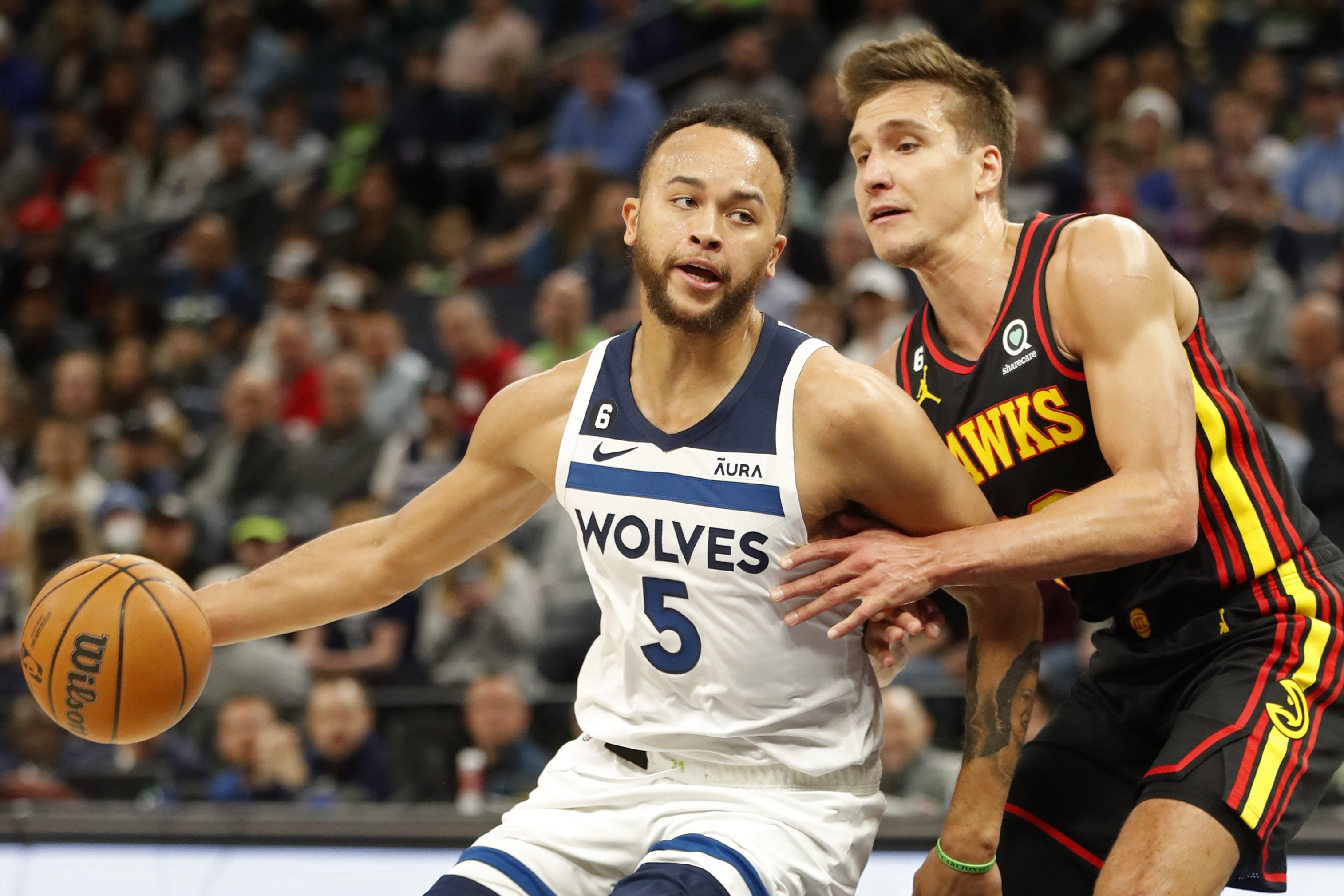 Minnesota Timberwolves forward Kyle Anderson (5) works around Atlanta Hawks forward Bogdan Bogdanovic, right, in the first quarter of an NBA basketball game Wednesday, March 22, 2023, in Minneapolis. (AP Photo/Bruce Kluckhohn)