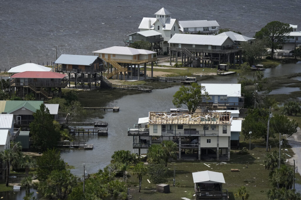 In this photo made in a flight provided by mediccorps.org, a home with a damaged roof is seen in Dekle Beach, Fla., following the passage of Hurricane Idalia, Wednesday, Aug. 30, 2023. (AP Photo/Rebecca Blackwell)