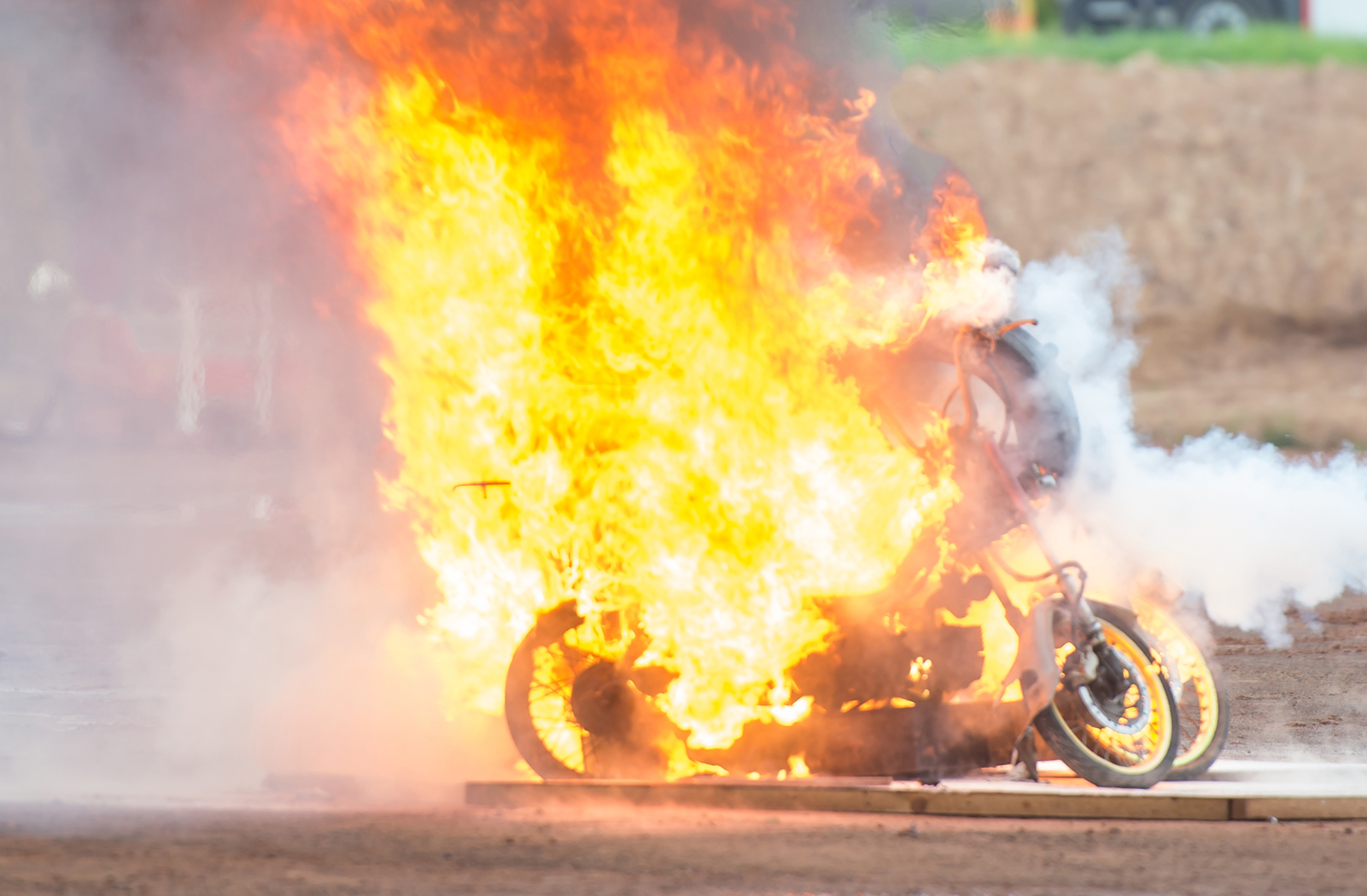 firefighters with motorcycle burning from explosive