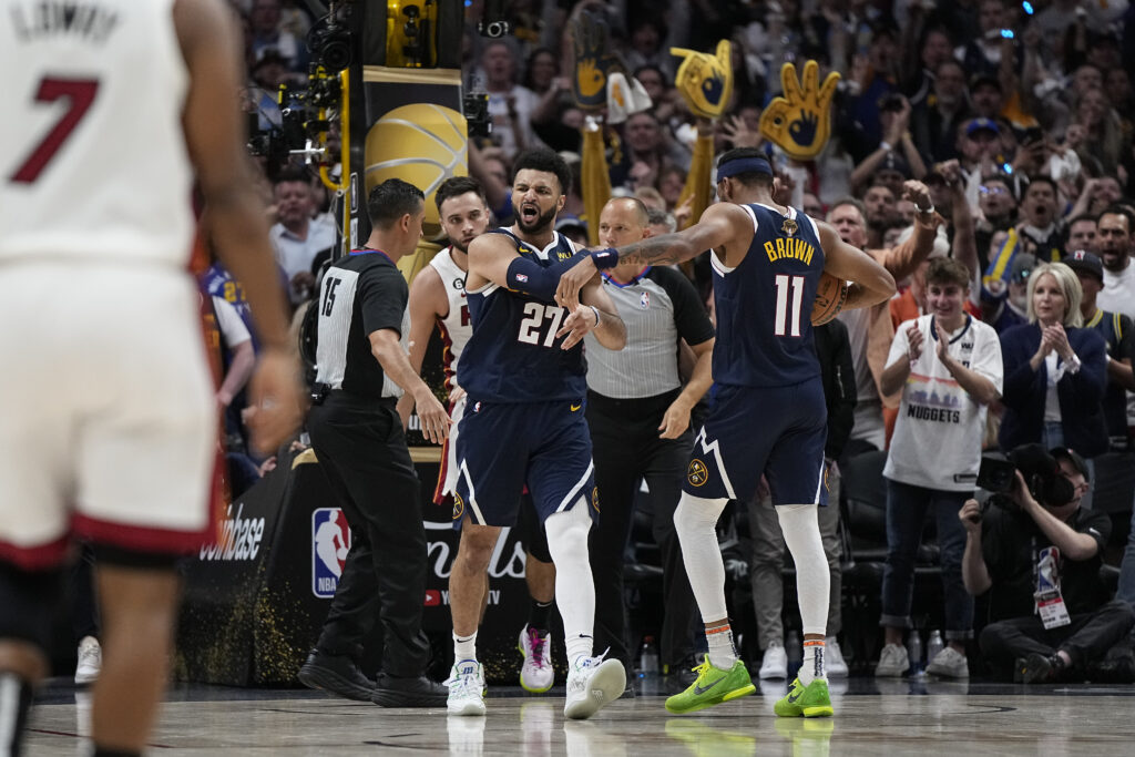 Denver Nuggets guard Jamal Murray (27) reacts after dunking against the Miami Heat during the first half of Game 2 of basketball's NBA Finals, Sunday, June 4, 2023, in Denver. (AP Photo/Mark J. Terrill)
