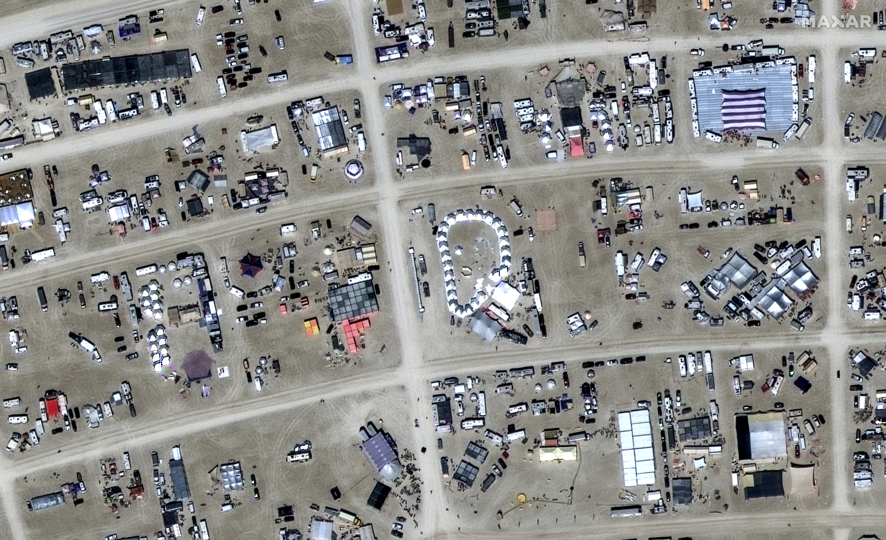 In this satellite photo provided by Maxar Technologies, an overview of Burning Man festival in Black Rock, Nev on Sunday, Aug. 27, 2023.  (©2023 Maxar Technologies via AP)