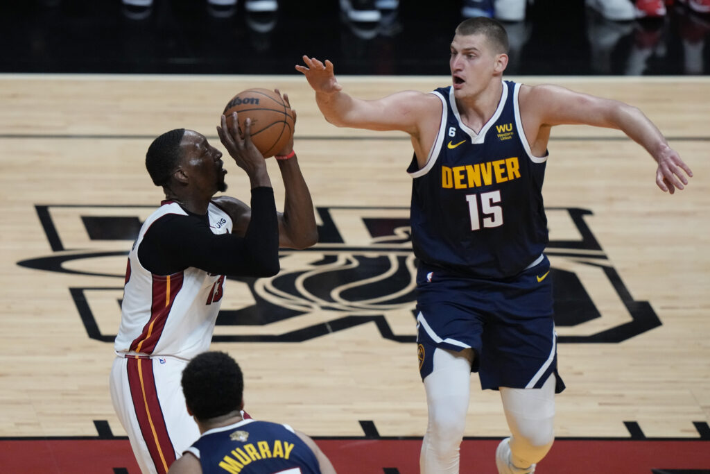 Denver Nuggets center Nikola Jokic (15) defends Miami Heat center Bam Adebayo (13) during the first half of Game 4 of the basketball NBA Finals, Friday, June 9, 2023, in Miami. (AP Photo/Lynne Sladky)