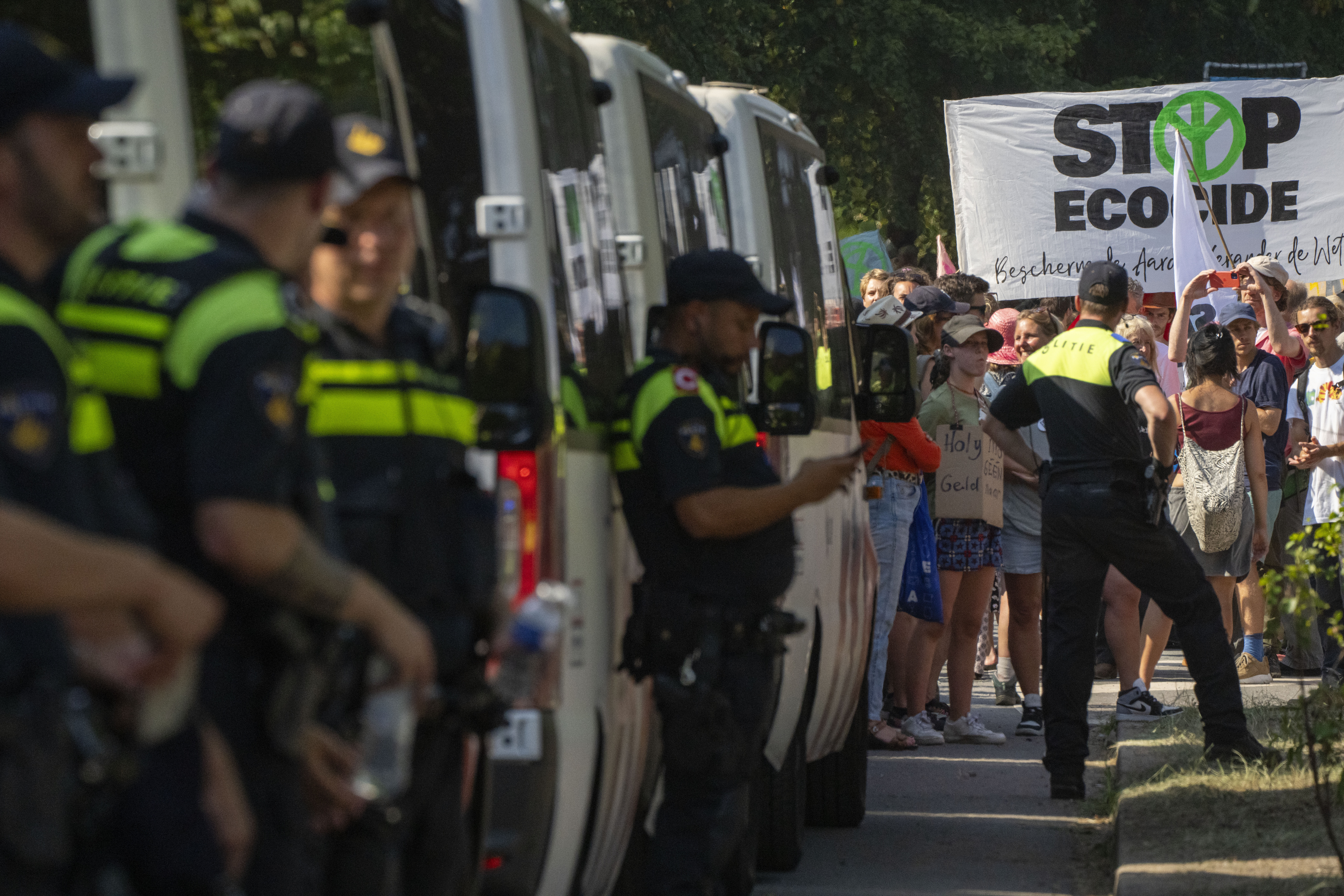 Police vehicles line up as protestors block a highway during a climate protest of Extinction Rebellion and other activists near the Dutch parliament in The Hague, Netherlands, Saturday, Sept. 9, 2023. (AP Photo/Peter Dejong)