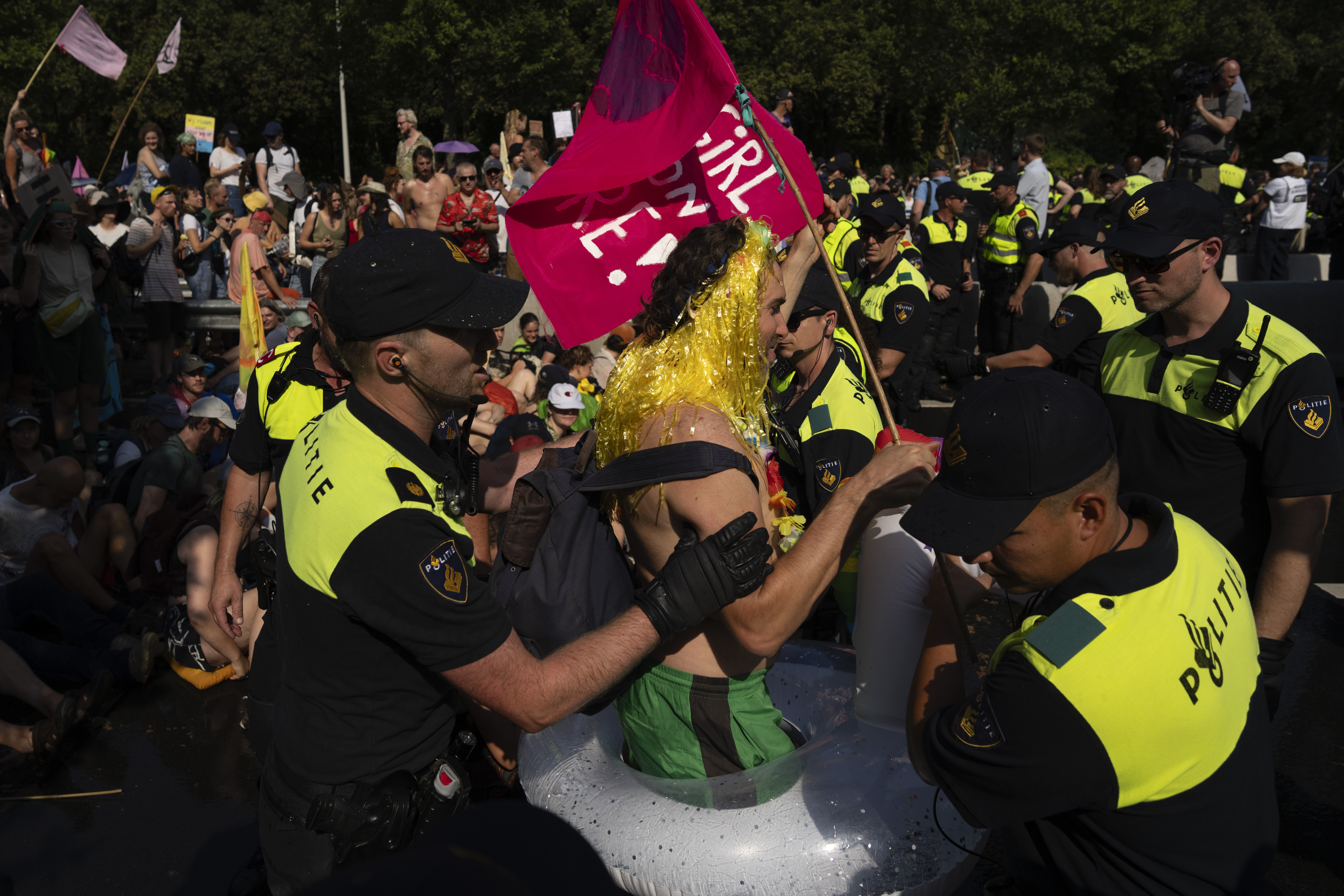 Police arrest protestors who blocked a highway during a climate protest of Extinction Rebellion and other activists near the Dutch parliament in The Hague, Netherlands, Saturday, Sept. 9, 2023. (AP Photo/Peter Dejong)