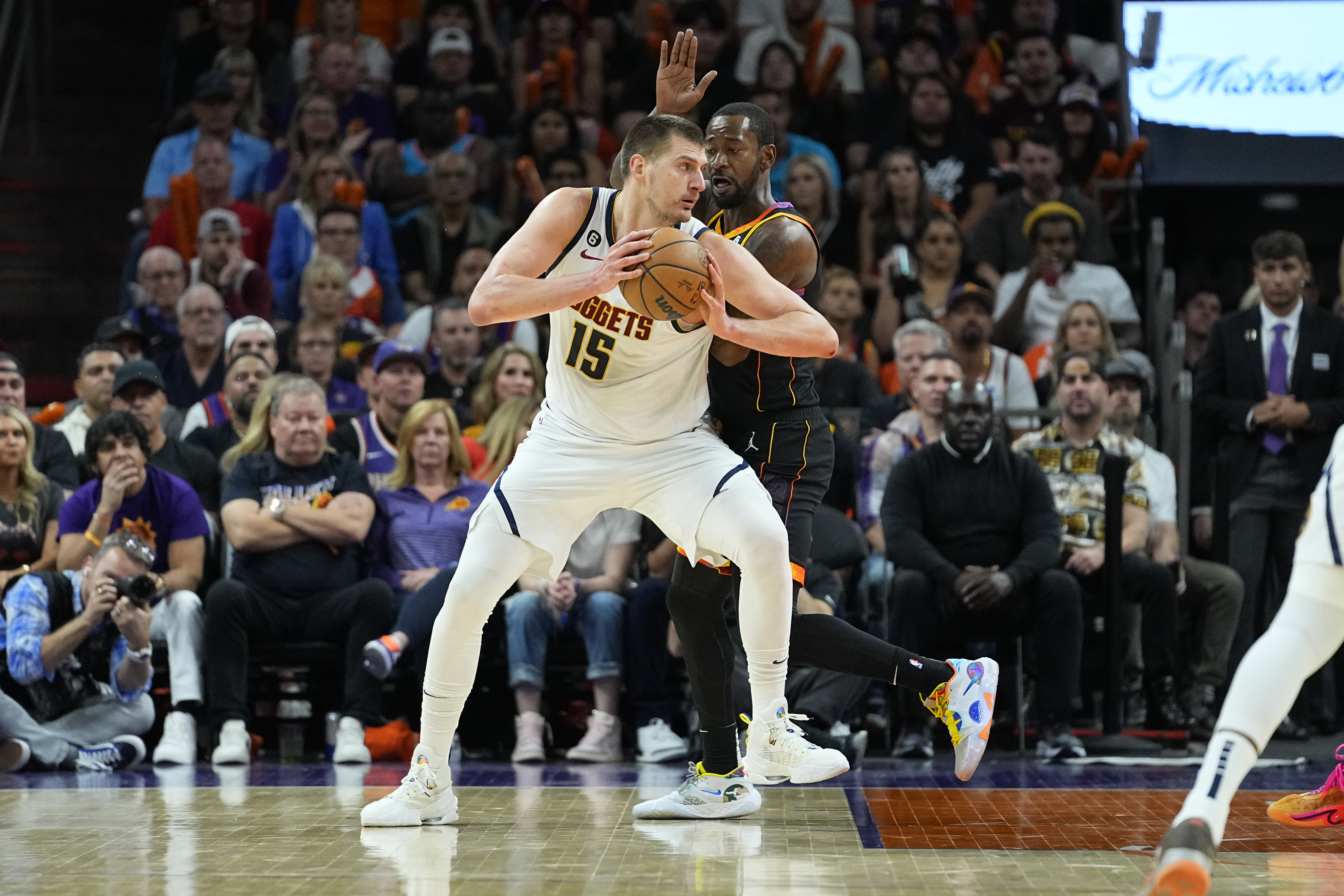 Denver Nuggets center Nikola Jokic (15) backs down against the Phoenix Suns during the first half of Game 6 of an NBA basketball Western Conference semifinal game, Thursday, May 11, 2023, in Phoenix. (AP Photo/Matt York)