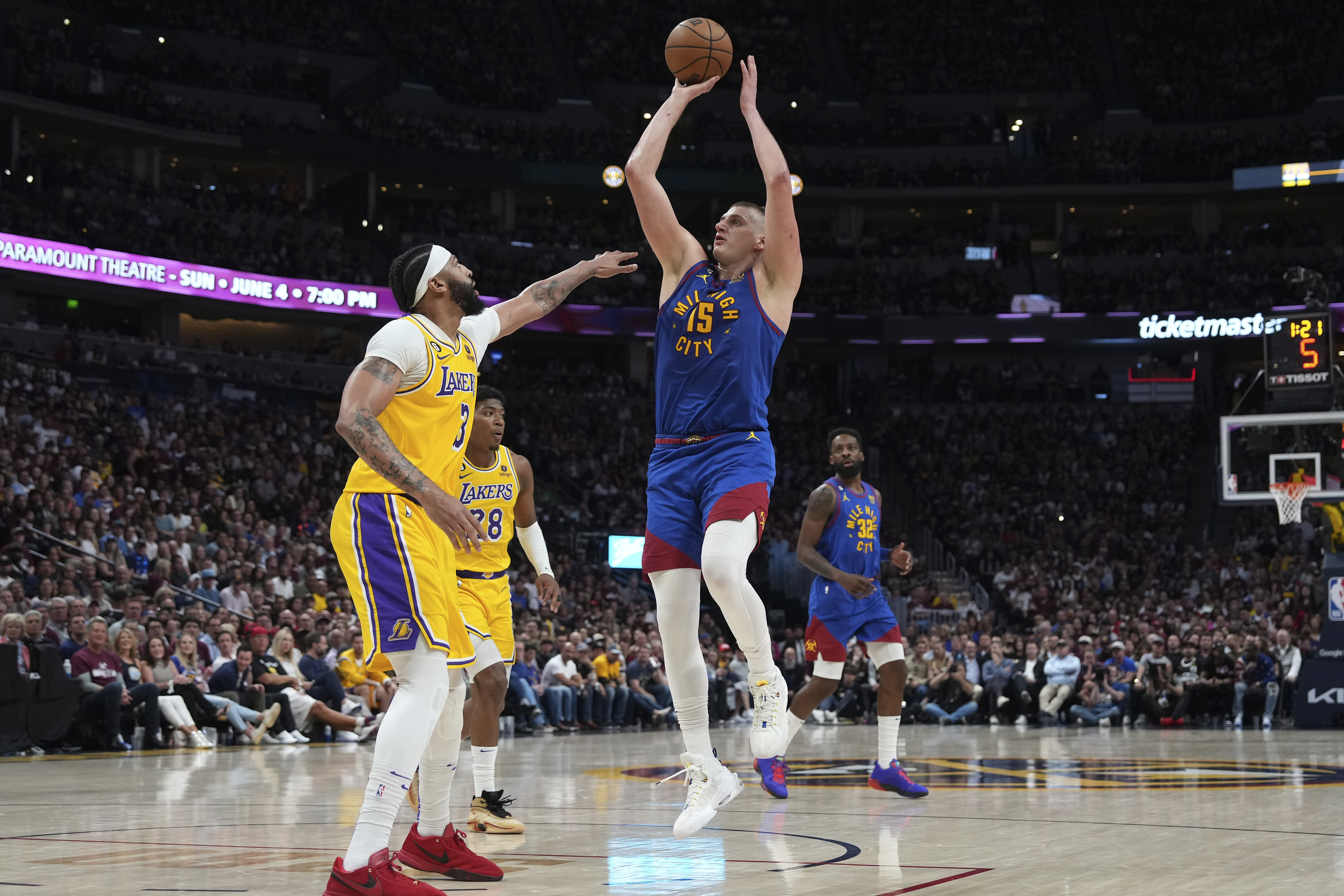 Denver Nuggets center Nikola Jokic (15) shoots over Los Angeles Lakers forward Anthony Davis (3) during the second half of Game 1 of the NBA basketball Western Conference Finals series, Tuesday, May 16, 2023, in Denver. (AP Photo/Jack Dempsey)