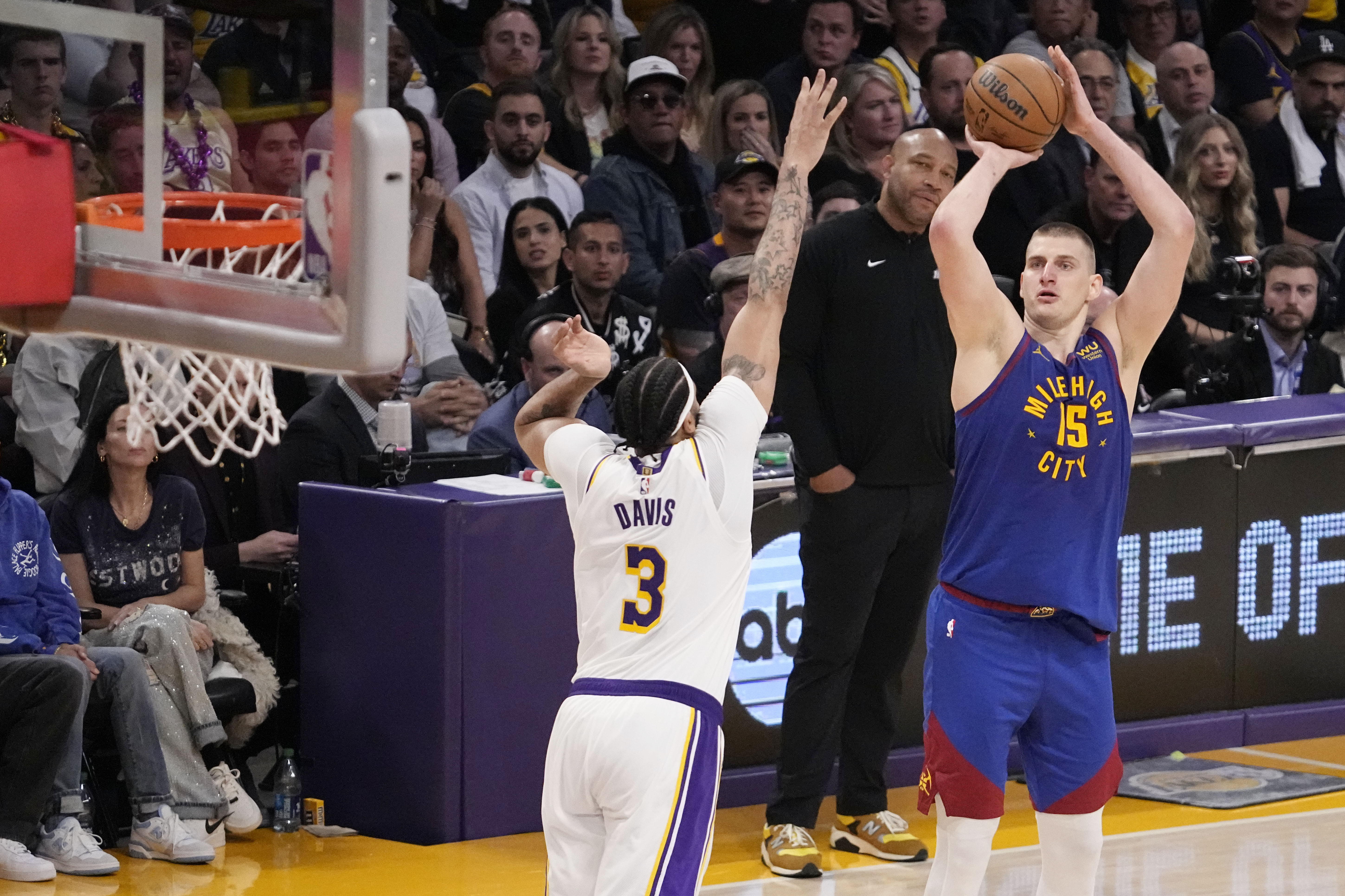 Denver Nuggets center Nikola Jokic (15) shoots over Los Angeles Lakers forward Anthony Davis (3) in the second half of Game 3 of the NBA basketball Western Conference Final series Saturday, May 20, 2023, in Los Angeles. (AP Photo/Mark J. Terrill)
