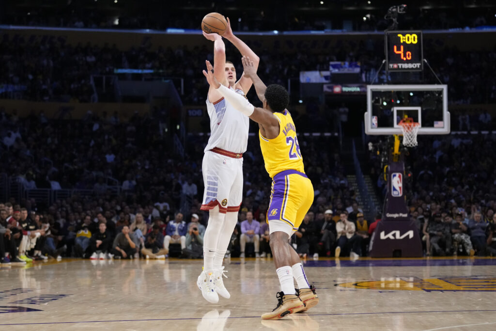 Denver Nuggets center Nikola Jokic shoots over Los Angeles Lakers forward Rui Hachimura (28) in the second half of Game 4 of the NBA basketball Western Conference Final series Monday, May 22, 2023, in Los Angeles. (AP Photo/Ashley Landis)