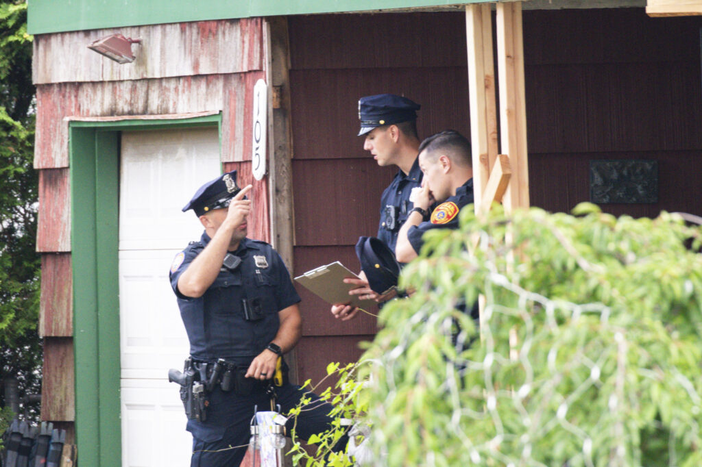 Police officers arrive to the house where a suspect has been taken into custody on New York's Long Island in connection with a long-unsolved string of killings, Friday, July 14, 2023, in Massapequa, New York. (AP Photo/Eduardo Munoz Alvarez)