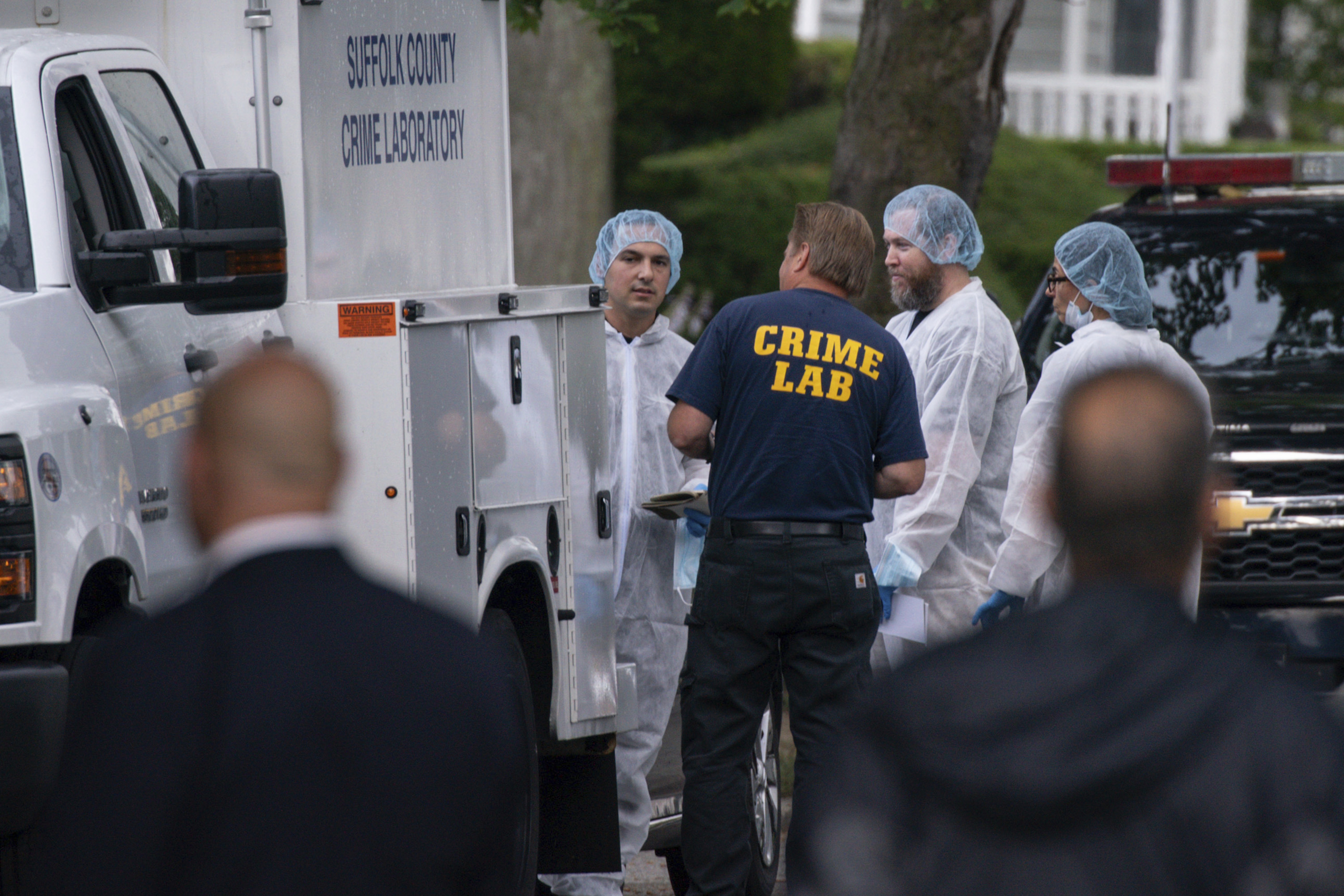 Crime laboratory officers arrive to the house where a suspect has been taken into custody on New York's Long Island in connection with a long-unsolved string of killings, Friday, July 14, 2023, in Massapequa, New York. (AP Photo/Eduardo Munoz Alvarez)