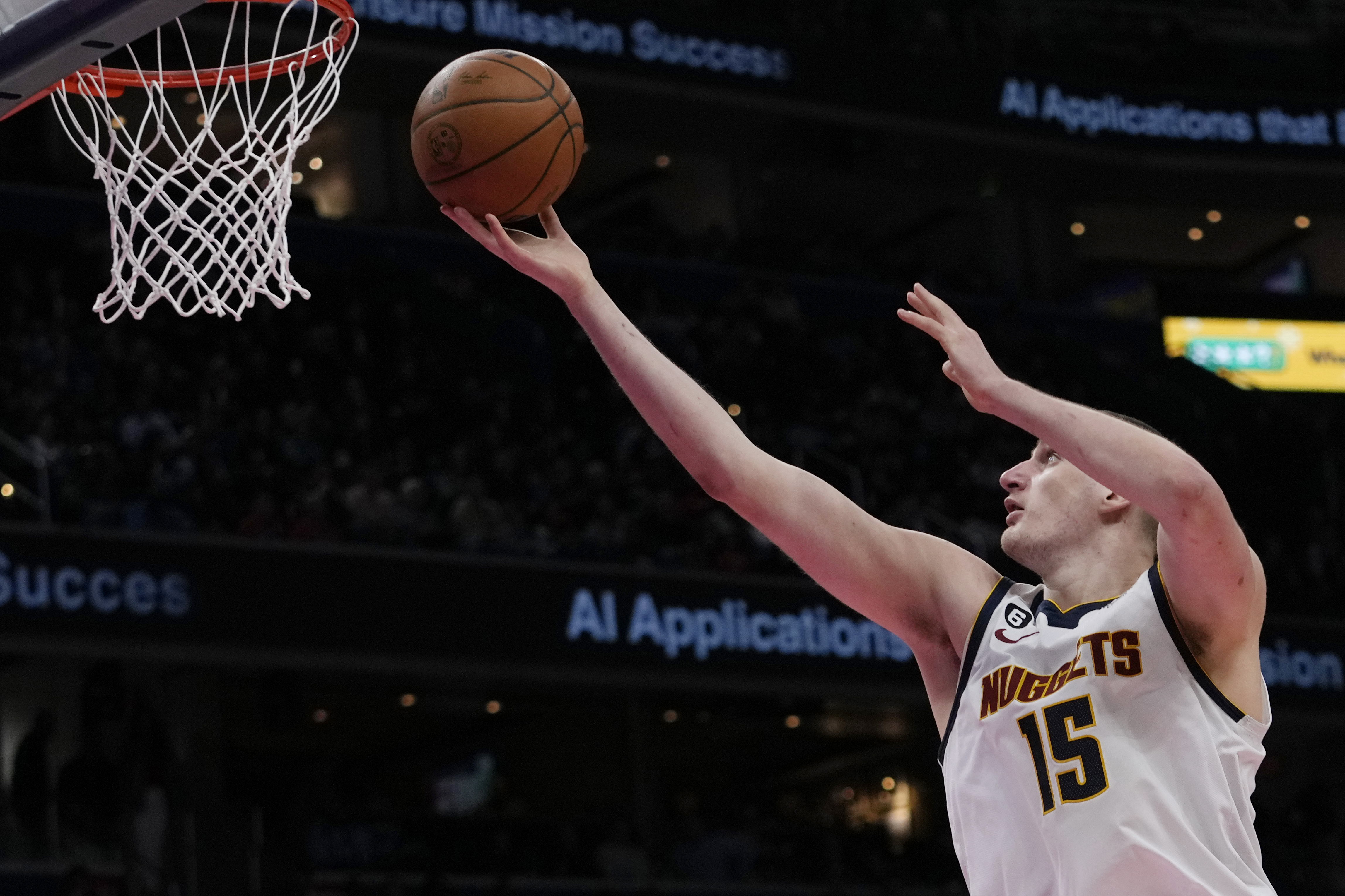 Denver Nuggets center Nikola Jokic (15) goes up for a shot during the second half of an NBA basketball against the Washington Wizards, game Wednesday, March 22, 2023, in Washington. The Nuggets won 118-104. (AP Photo/Carolyn Kaster)