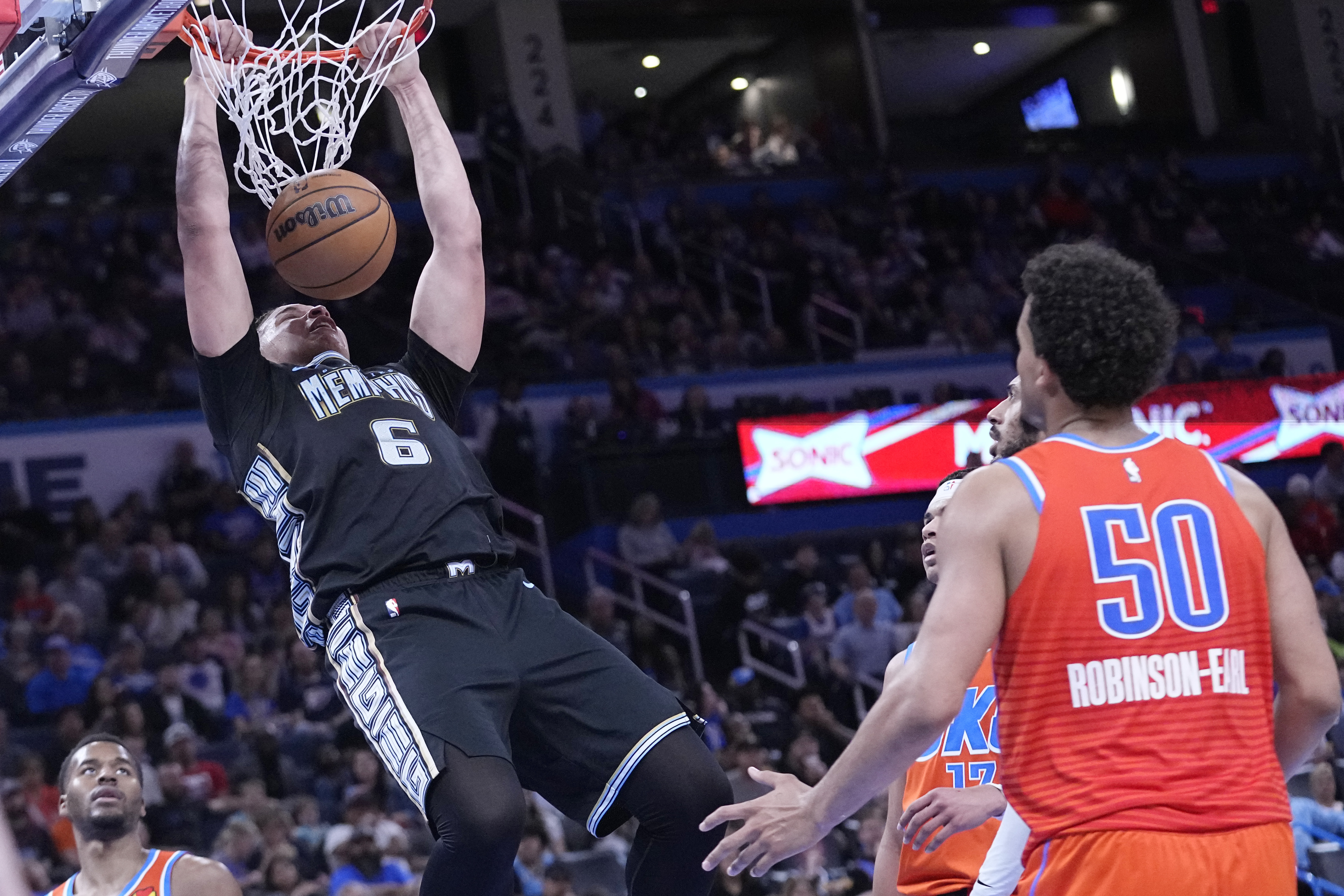 Memphis Grizzlies forward Kenneth Lofton Jr. (6) dunks in front of Oklahoma City Thunder forward Jeremiah Robinson-Earl (50) in the second half of an NBA basketball game Sunday, April 9, 2023, in Oklahoma City. (AP Photo/Sue Ogrocki)