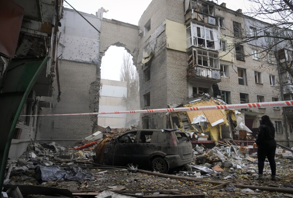 A woman stands at the scene of night shelling in Mykolaiv, Ukraine, Friday, Nov. 11, 2022. (AP Photo/Efrem Lukatsky)