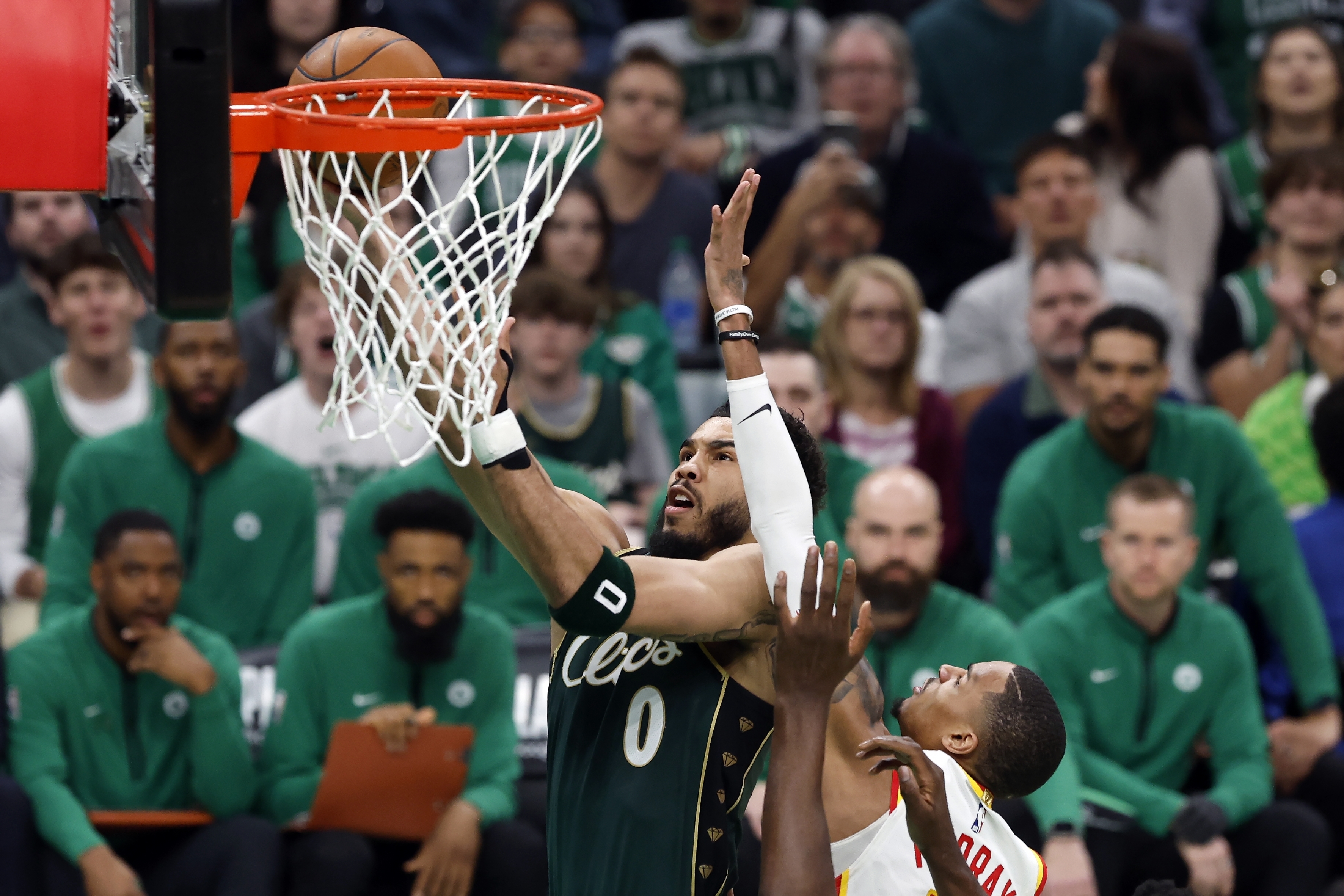 Boston Celtics' Jayson Tatum (0) shoots against Atlanta Hawks' Dejounte Murray in the first half during Game 1 in the first round of the NBA basketball playoffs, Saturday, April 15, 2023, in Boston. (AP Photo/Michael Dwyer)