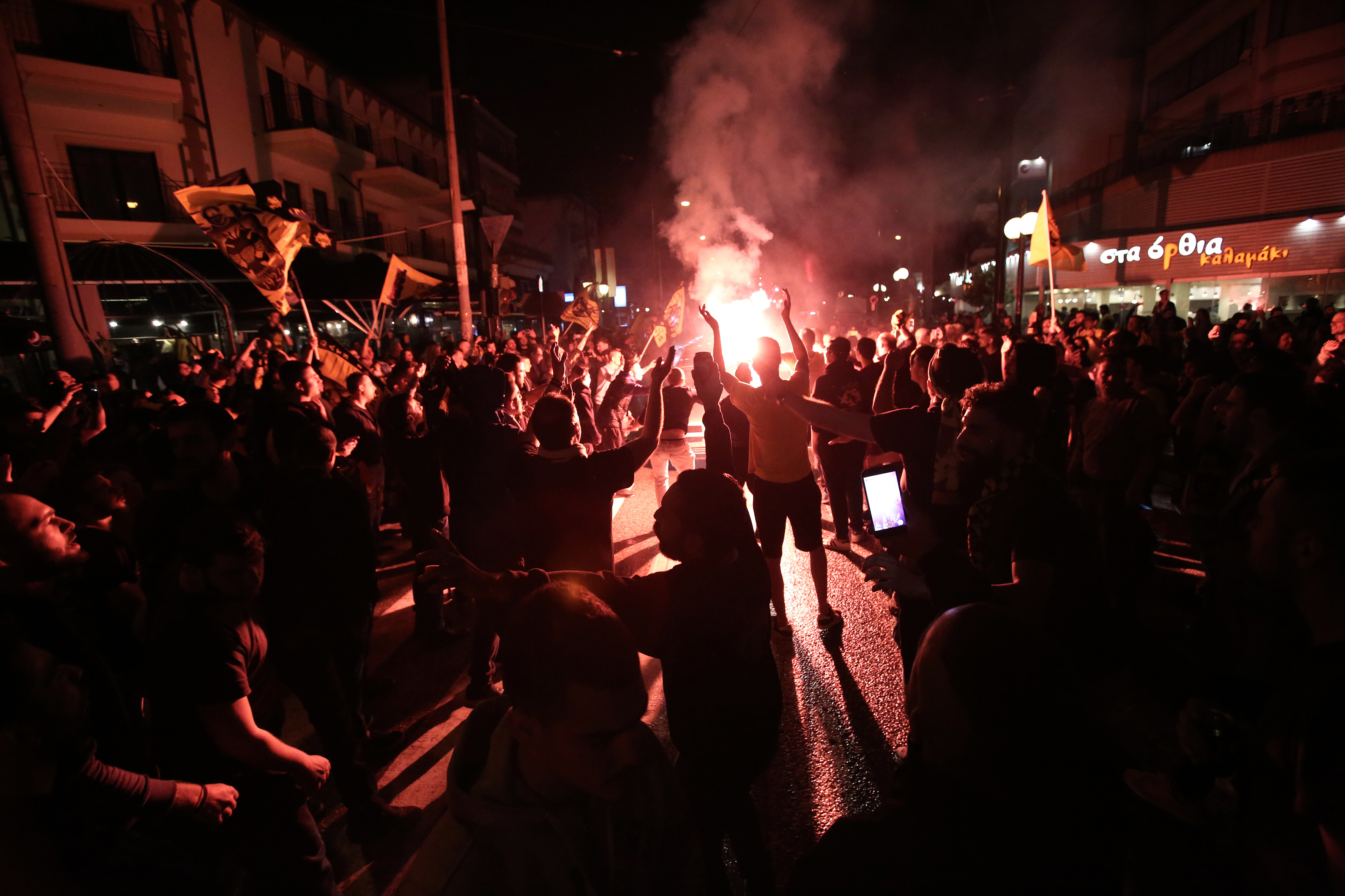 Fans of AEK Athens celebrate after the victory at the final basketball game of the FIBA Champions League Final Four
