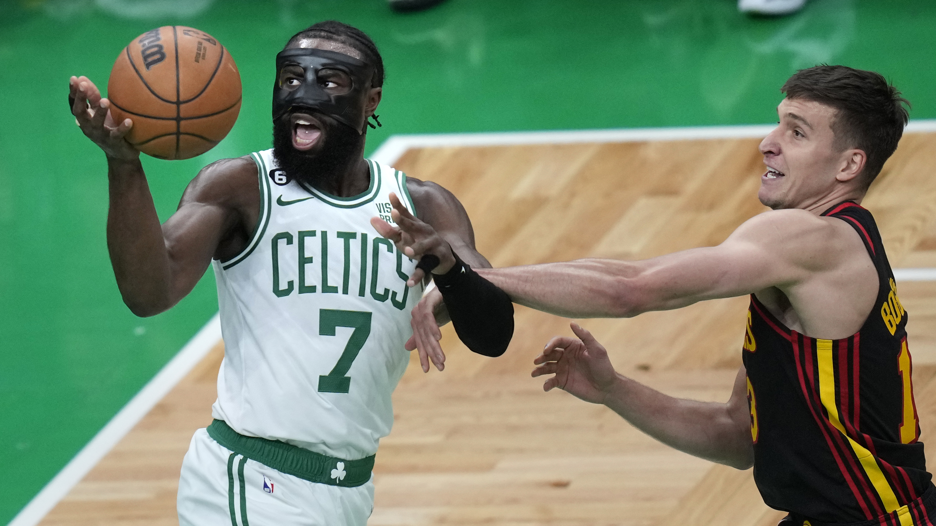 Boston Celtics guard Jaylen Brown (7) is fouled by Atlanta Hawks guard Bogdan Bogdanovic on a drive to the basket during Game 2 in the first round of the NBA basketball playoffs, Tuesday, April 18, 2023, in Boston. (AP Photo/Charles Krupa)