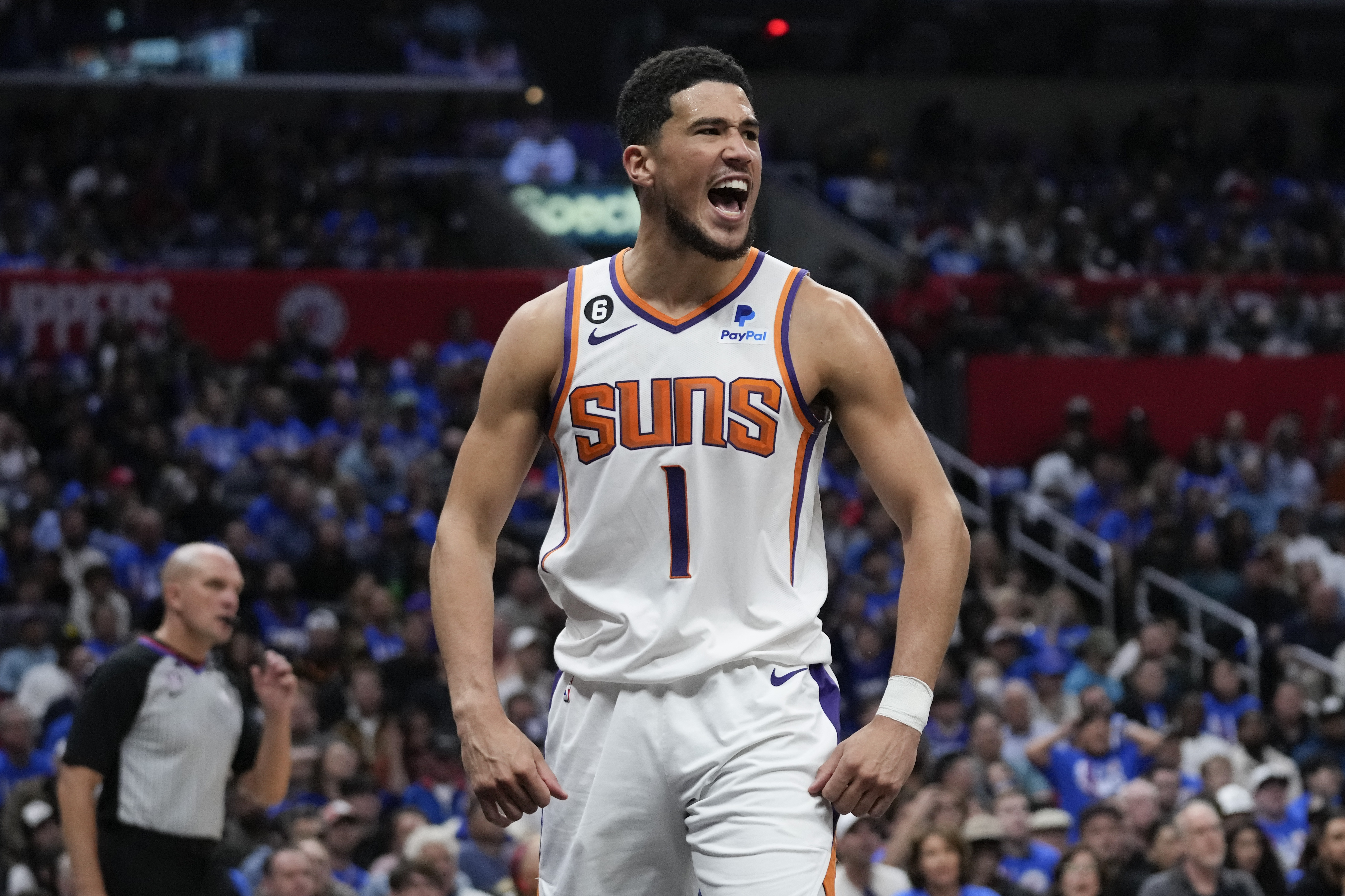Phoenix Suns guard Devin Booker (1) reacts after scoring during the second half of Game 3 of a first-round NBA basketball playoff series against the Los Angeles Clippers in Los Angeles, Thursday, April 20, 2023. (AP Photo/Ashley Landis)