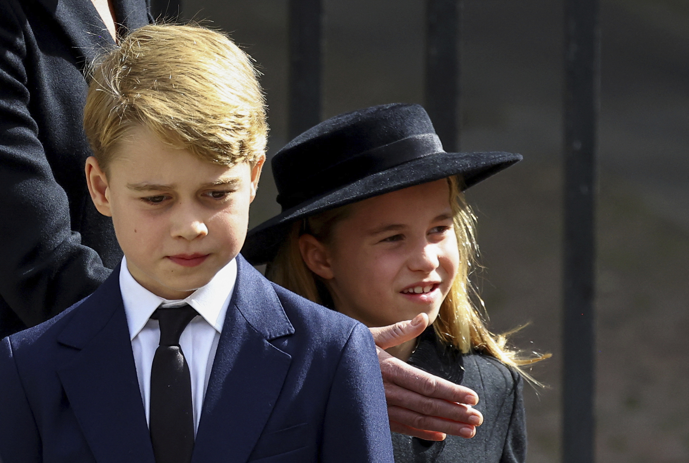 Britain's Prince George and Princess Charlotte walk after a service at Westminster Abbey on the day of Queen Elizabeth II's state funeral and burial, in London, Monday Sept. 19, 2022. (Hannah Mckay/Pool Photo via AP)