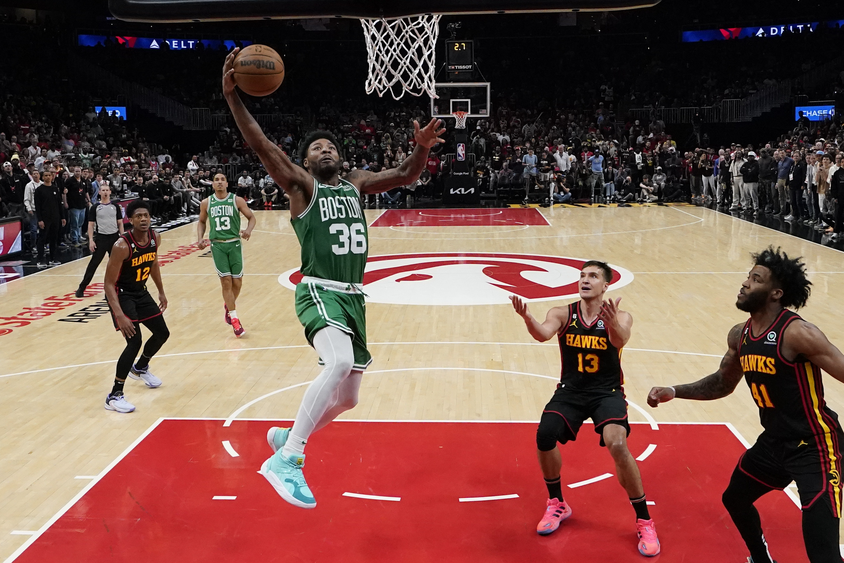Boston Celtics guard Marcus Smart (36) shoots and scores against Atlanta Hawks guard Bogdan Bogdanovic (13) during the second half of Game 4 of a first-round NBA basketball playoff series, Sunday, April 23, 2023, in Atlanta. (AP Photo/Brynn Anderson)