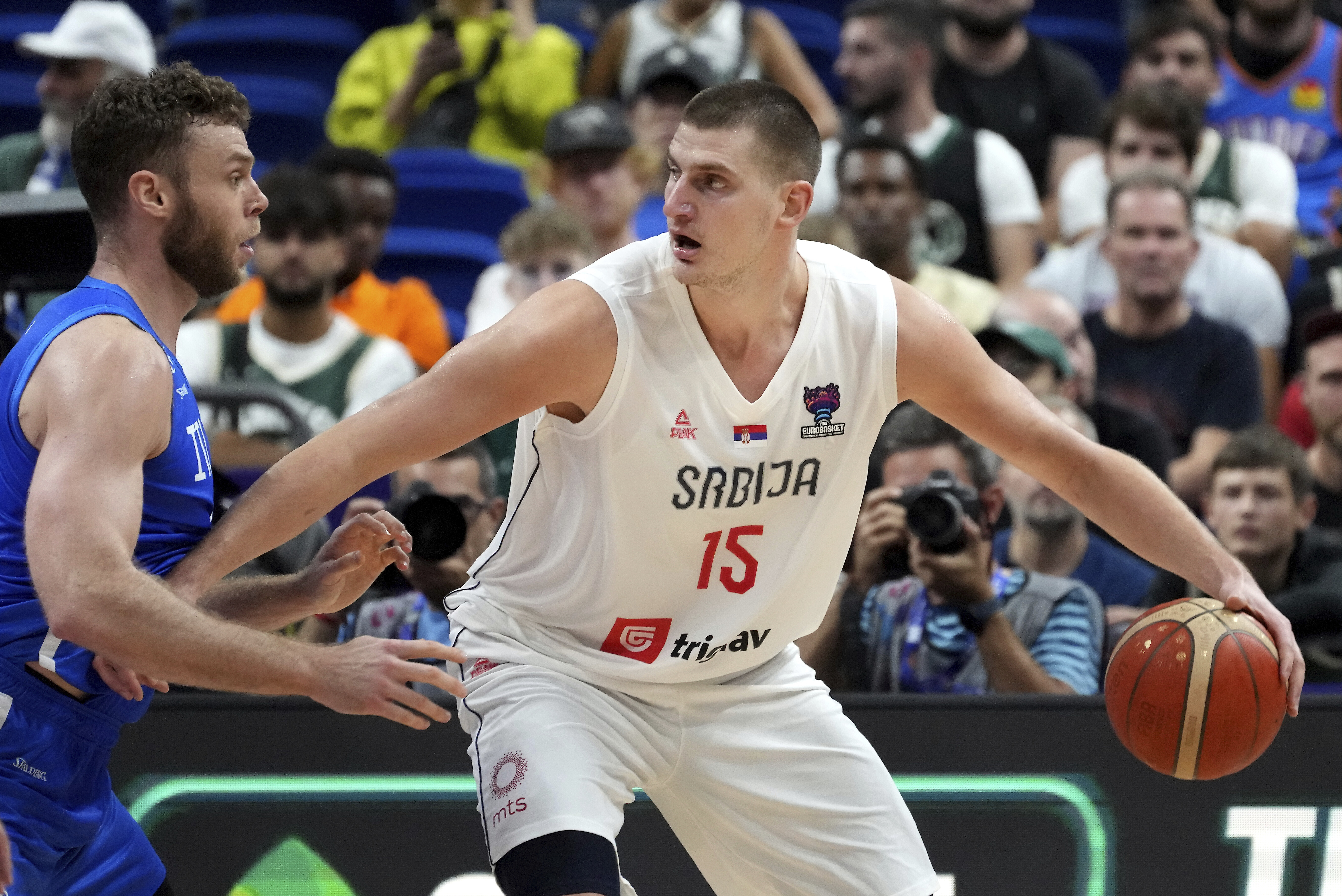 Serbia's Nikola Jokic, right, is challenged by Italy's Nicolo Melli, left, during the Eurobasket round of sixteen basketball match between Serbia and Italy in Berlin, Germany, Sunday, Sept. 11, 2022. (AP Photo/Michael Sohn)