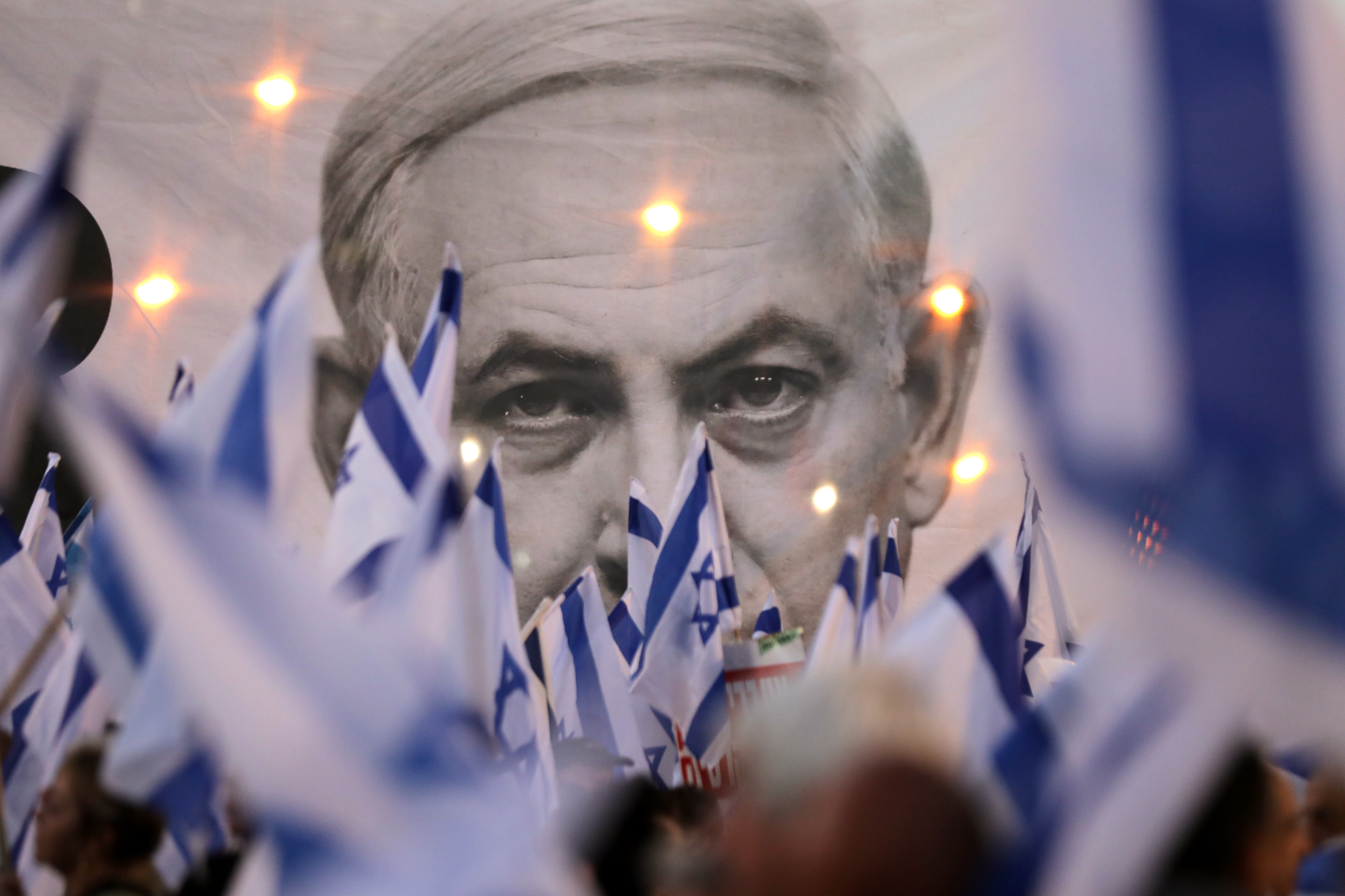 epa10574269 A banner depicts Israeli prime minister during a protest against the justice system reform in Tel Aviv, Israel, 15 April 2023. Mass protests continue across the country against the government justice system reform plan.  EPA-EFE/ABIR SULTAN