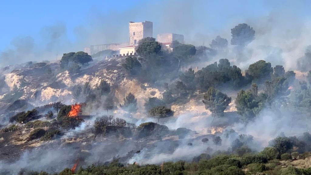 epa10770117 General view of a large fire that developed on the hill of San Michele and within a short time spread due to wind and high temperatures in Cagliari, Italy, 26 July 2023.  EPA-EFE/MANUEL SCORDO -- BEST QUALITY AVAILABLE --