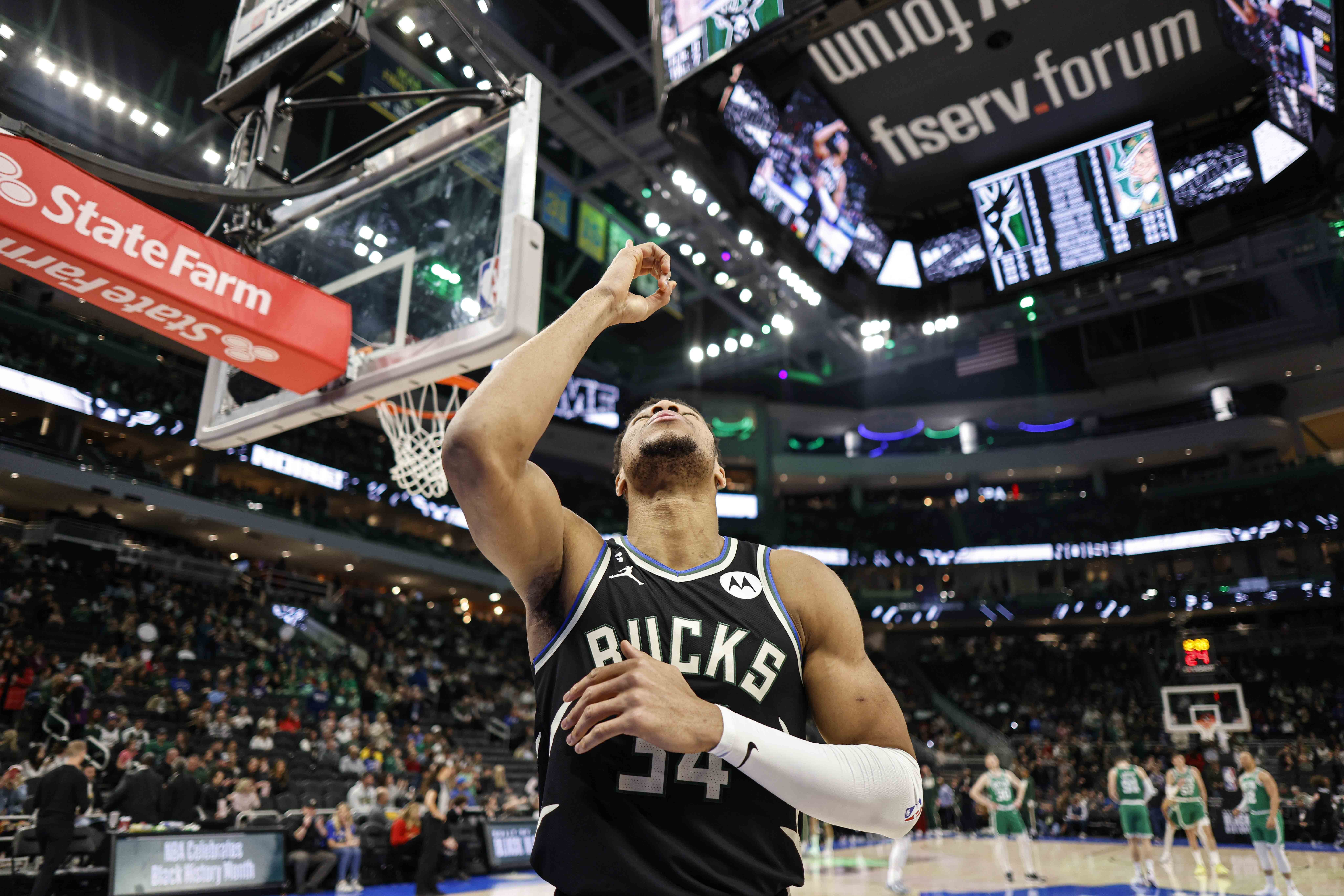 Milwaukee Bucks forward Giannis Antetokounmpo points up before their game against the Boston Celtics during an NBA basketball game, Tuesday, Feb. 14, 2023, in Milwaukee. (AP Photo/Jeffrey Phelps)