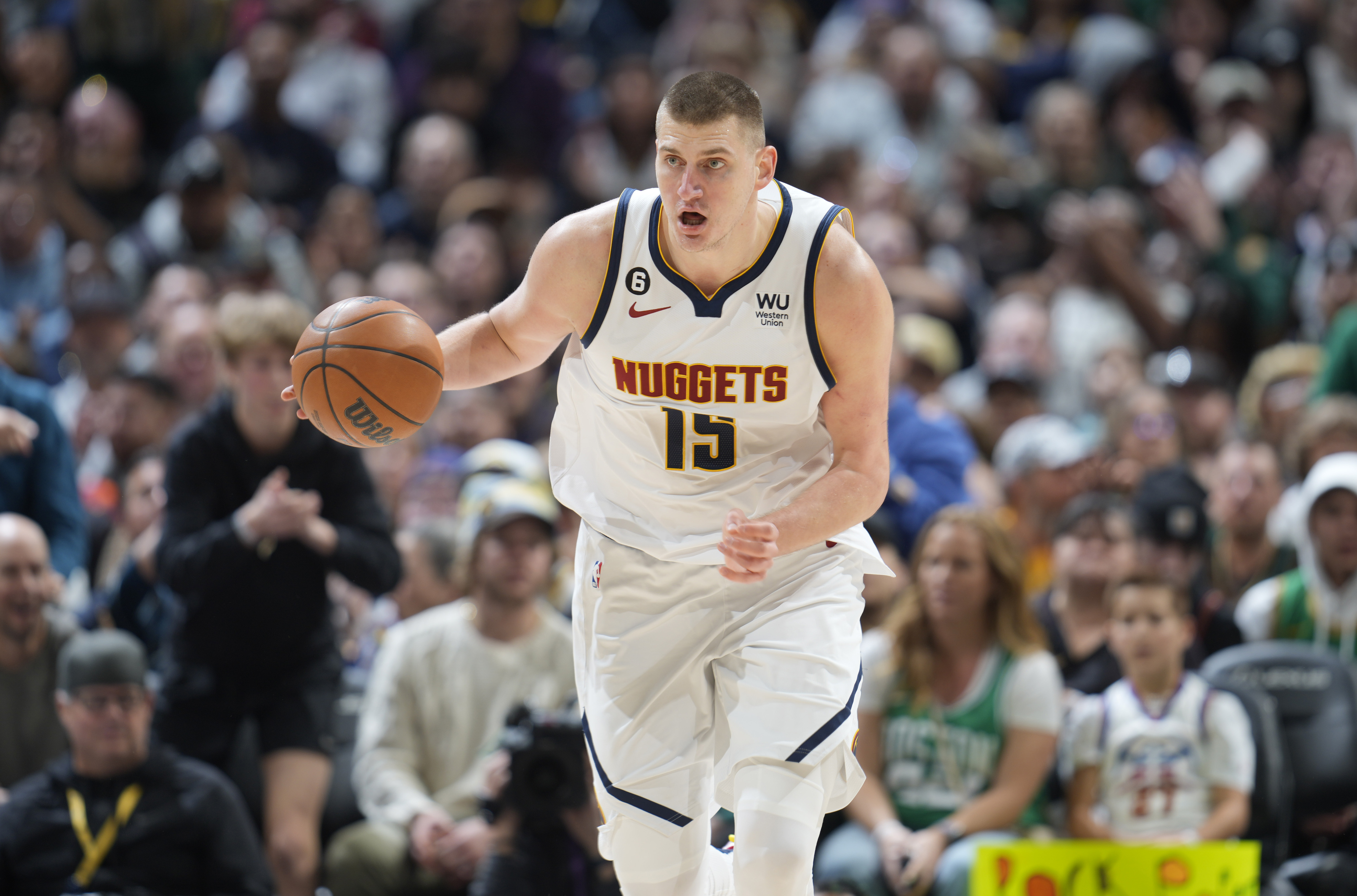 Denver Nuggets center Nikola Jokic collects a loose ball in the second half of an NBA basketball game against the Boston Celtics, Sunday, Jan. 1, 2023, in Denver. (AP Photo/David Zalubowski)