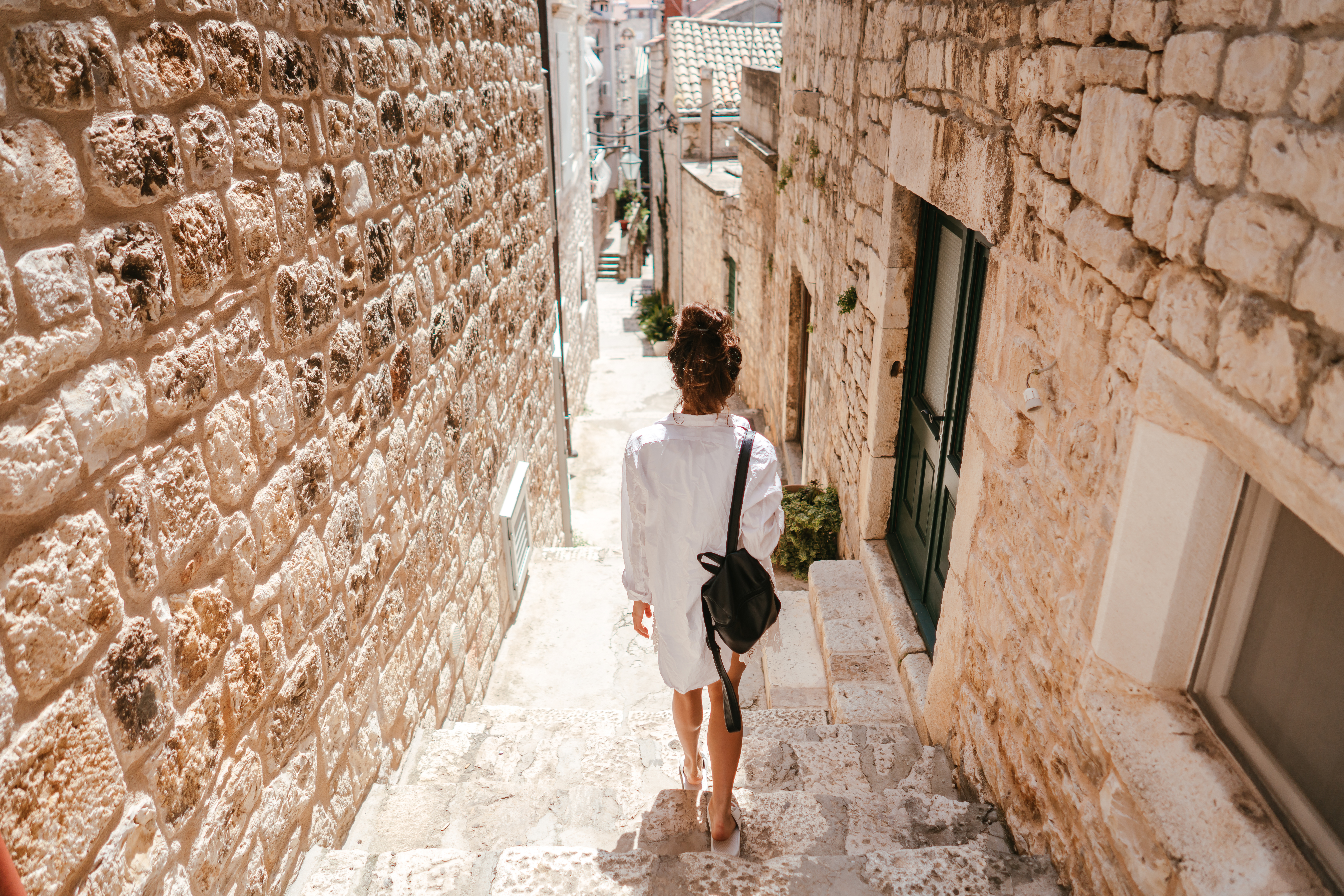 Young,Girl,Walking,Through,Ancient,Narrow,Streets,On,A,Beautiful