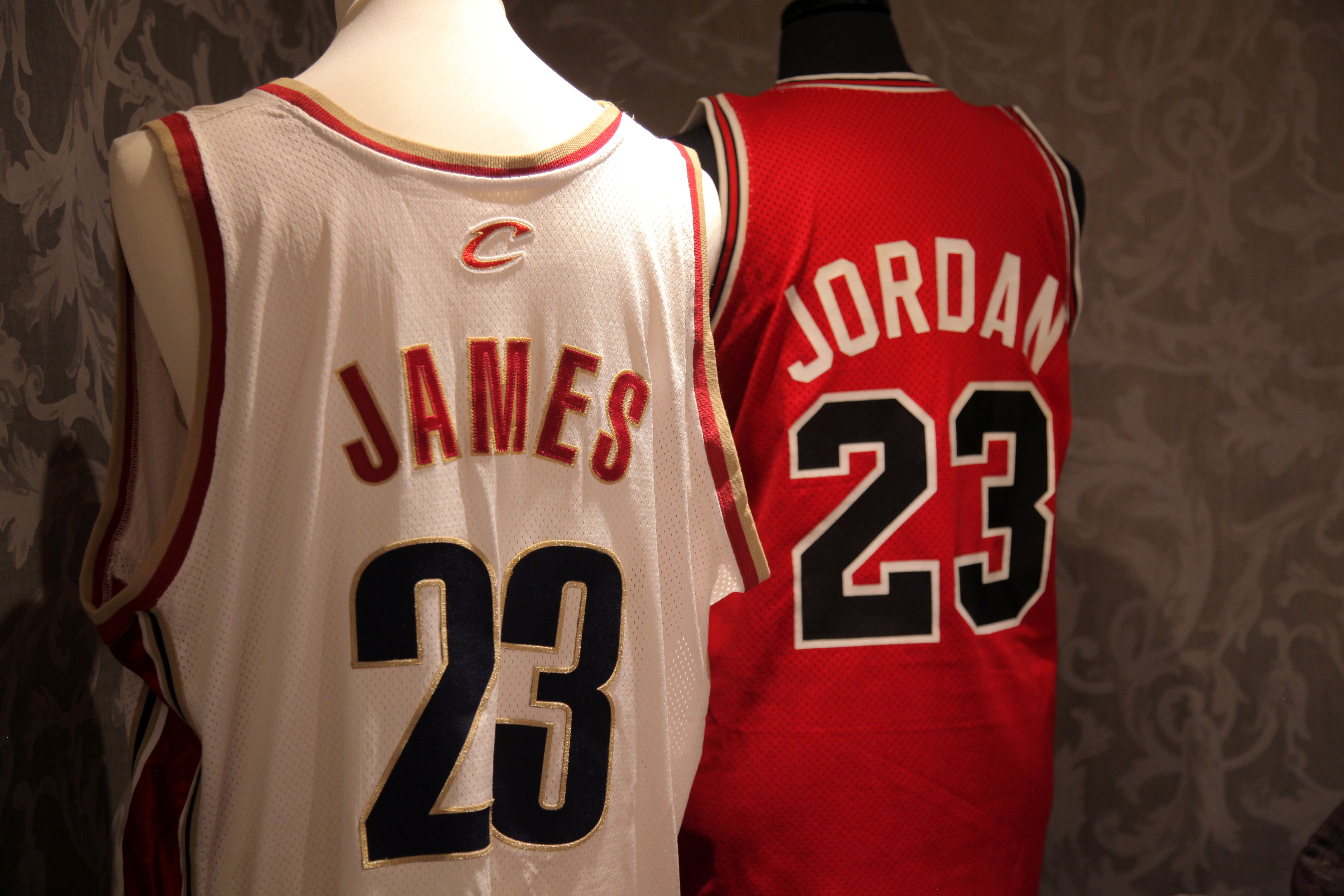 A Cleveland Cavaliers jersey worn by American basketball player Lebron James during the 2006 season and a 1986-1987 Chicago Bulls road jersey worn by American basketball player Michael Jordan are seen at a private display at the May Fair Hotel in London