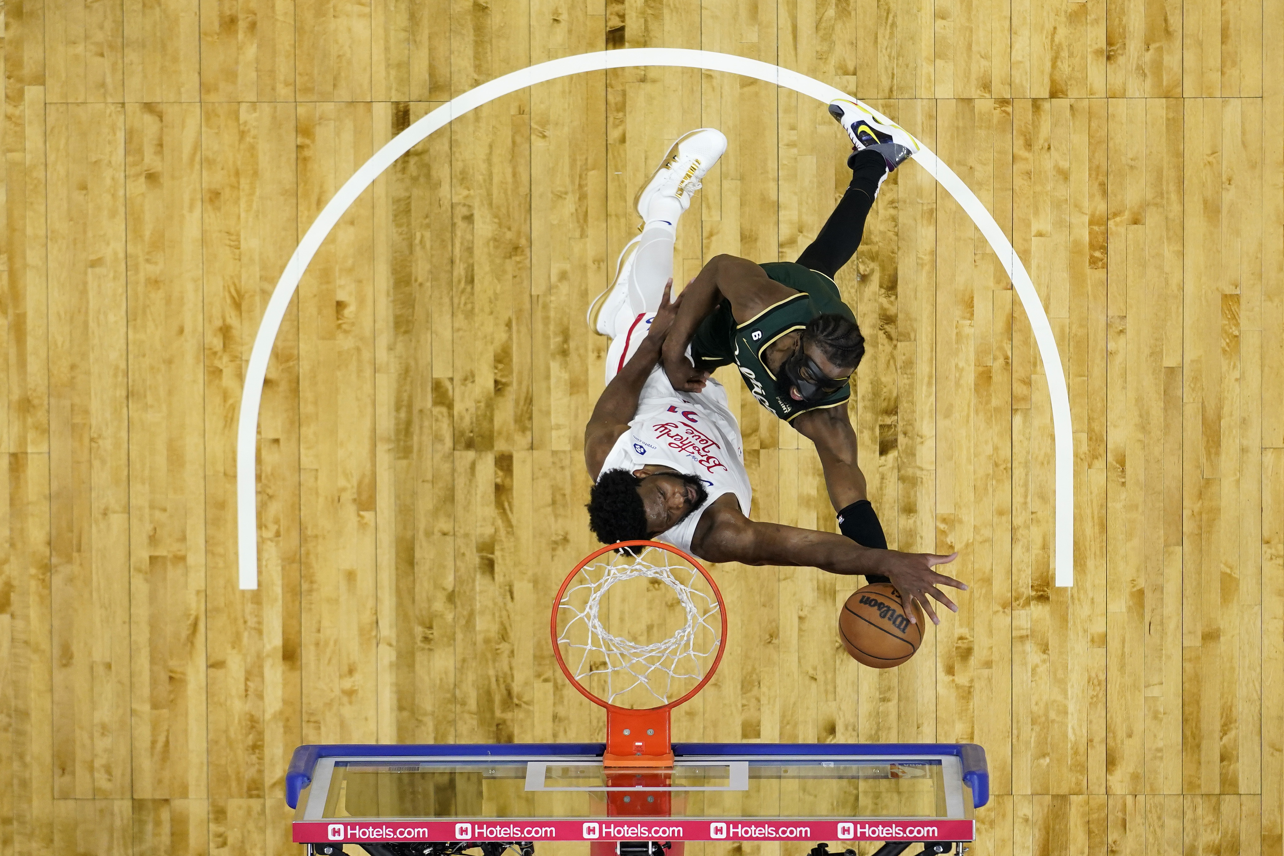 Boston Celtics' Jaylen Brown, right, goes up for a shot against Philadelphia 76ers' Joel Embiid during the second half of an NBA basketball game, Saturday, Feb. 25, 2023, in Philadelphia. (AP Photo/Matt Slocum)