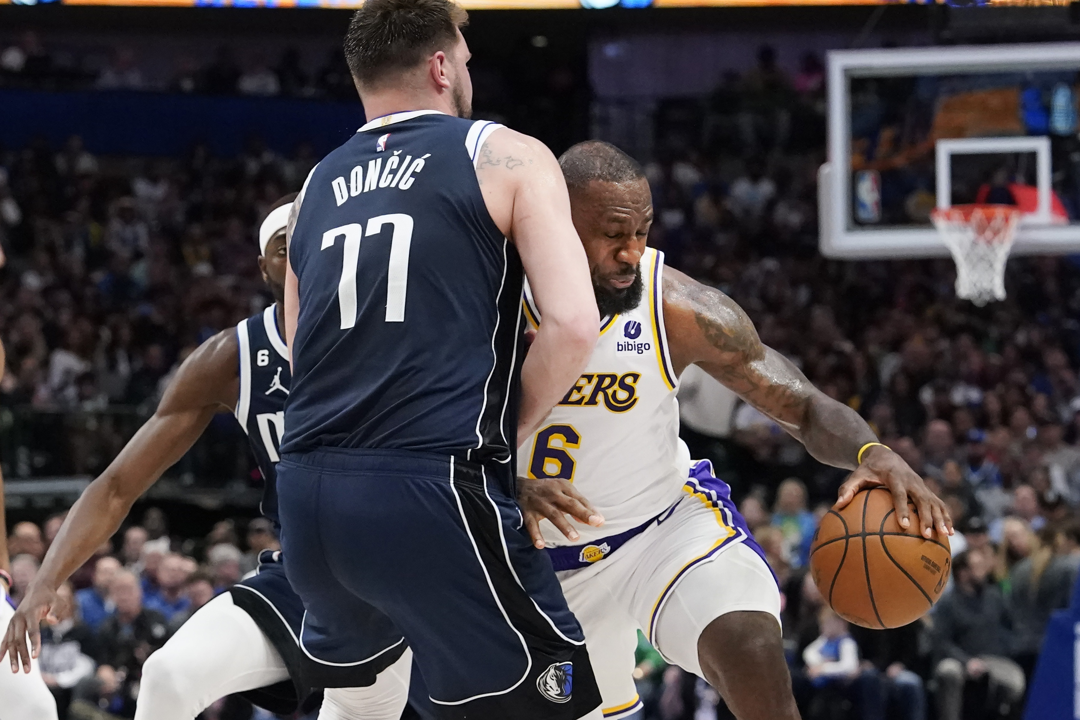 Los Angeles Lakers forward LeBron James (6) drives into Dallas Mavericks guard Luka Doncic (77) during the first half of an NBA basketball game in Dallas, Sunday, Feb. 26, 2023. (AP Photo/LM Otero)