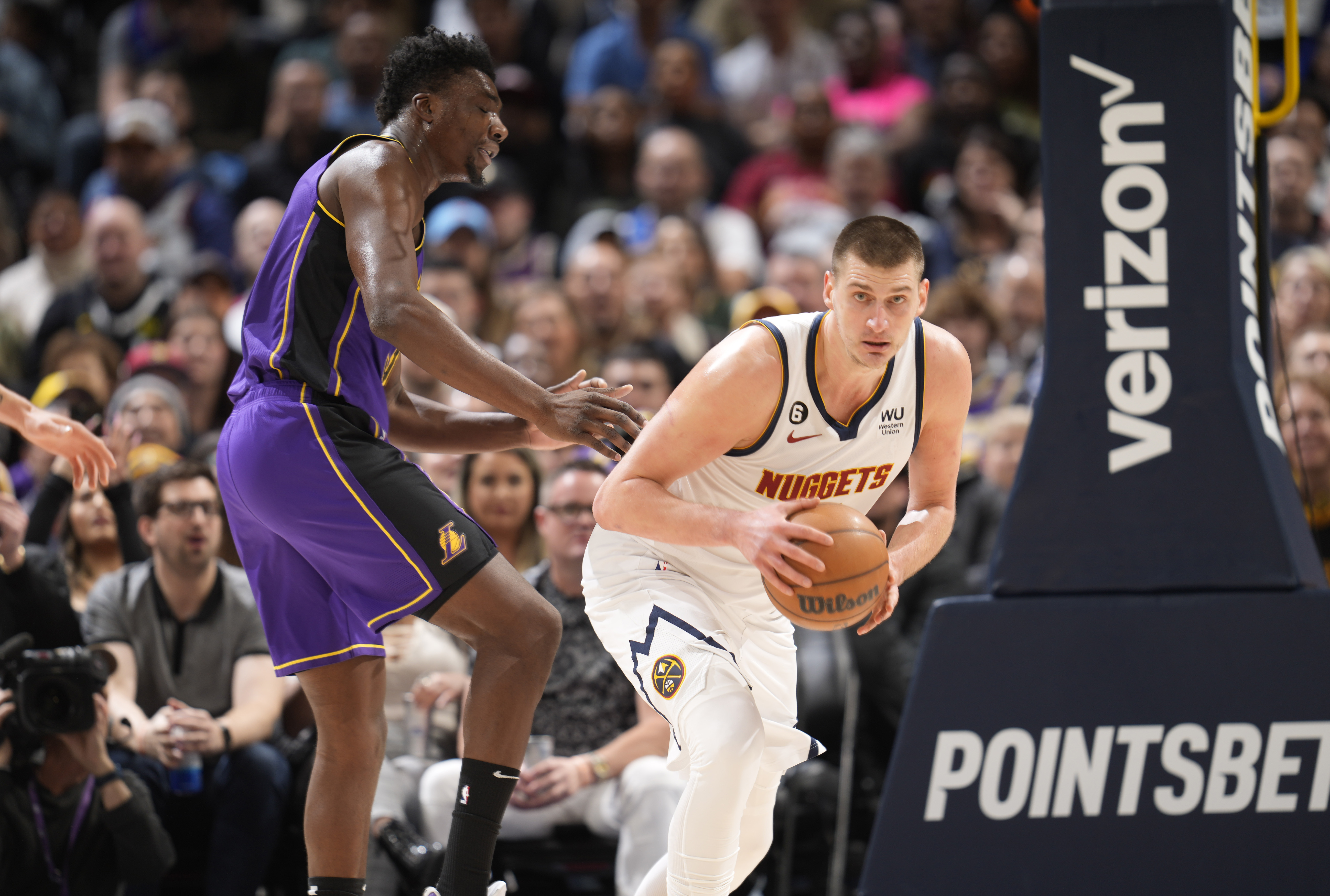 Denver Nuggets center Nikola Jokic, right, pulls in the ball as Los Angeles Lakers center Thomas Bryant defends in the first half of an NBA basketball game Monday, Jan. 9, 2023, in Denver. (AP Photo/David Zalubowski)
