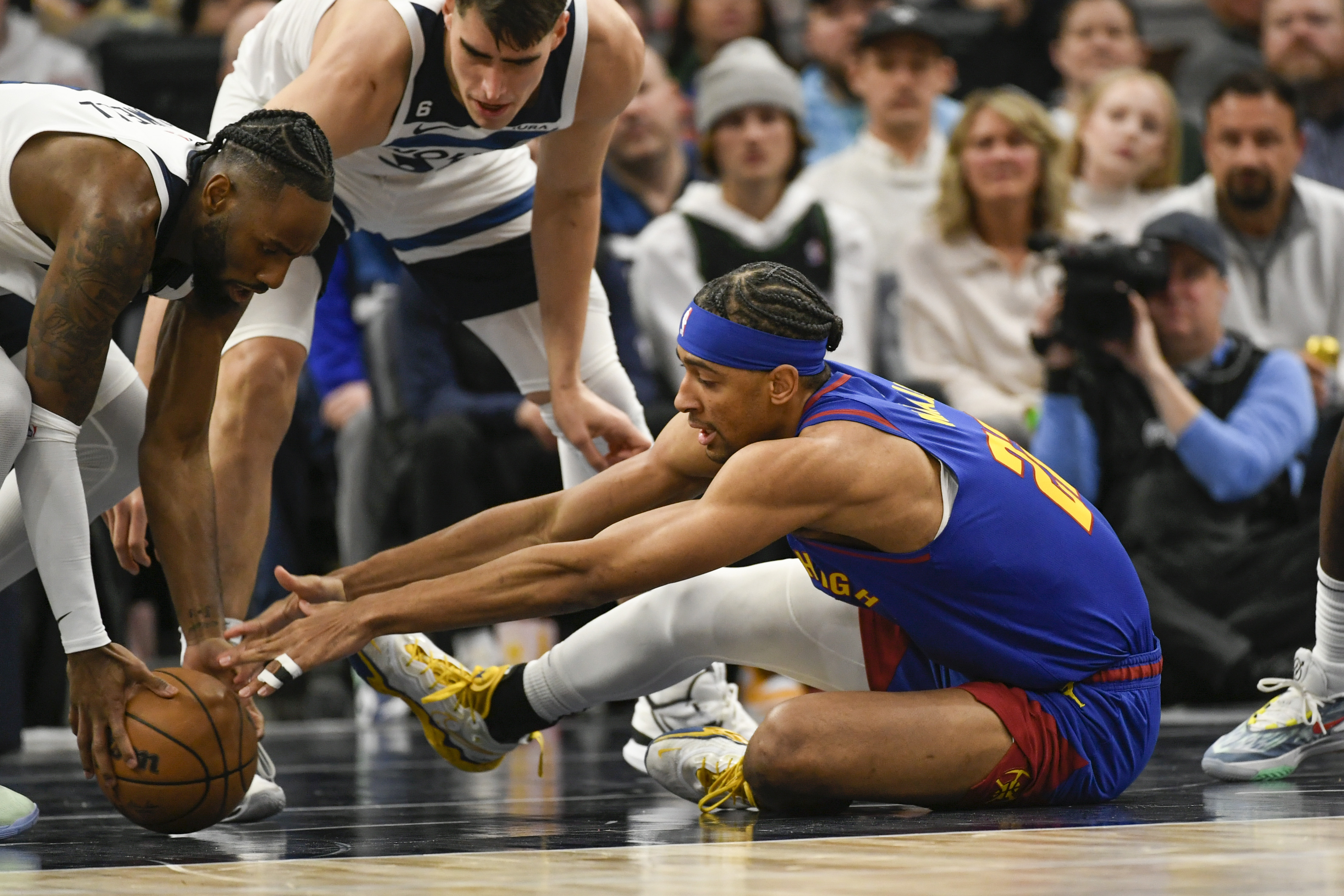 Denver Nuggets forward Zeke Nnaji, right, reaches for a loose ball as Minnesota Timberwolves guard Jaylen Nowell, left, scoops it up during the first half of an NBA basketball game, Monday, Jan. 2, 2023, in Minneapolis. (AP Photo/Craig Lassig)