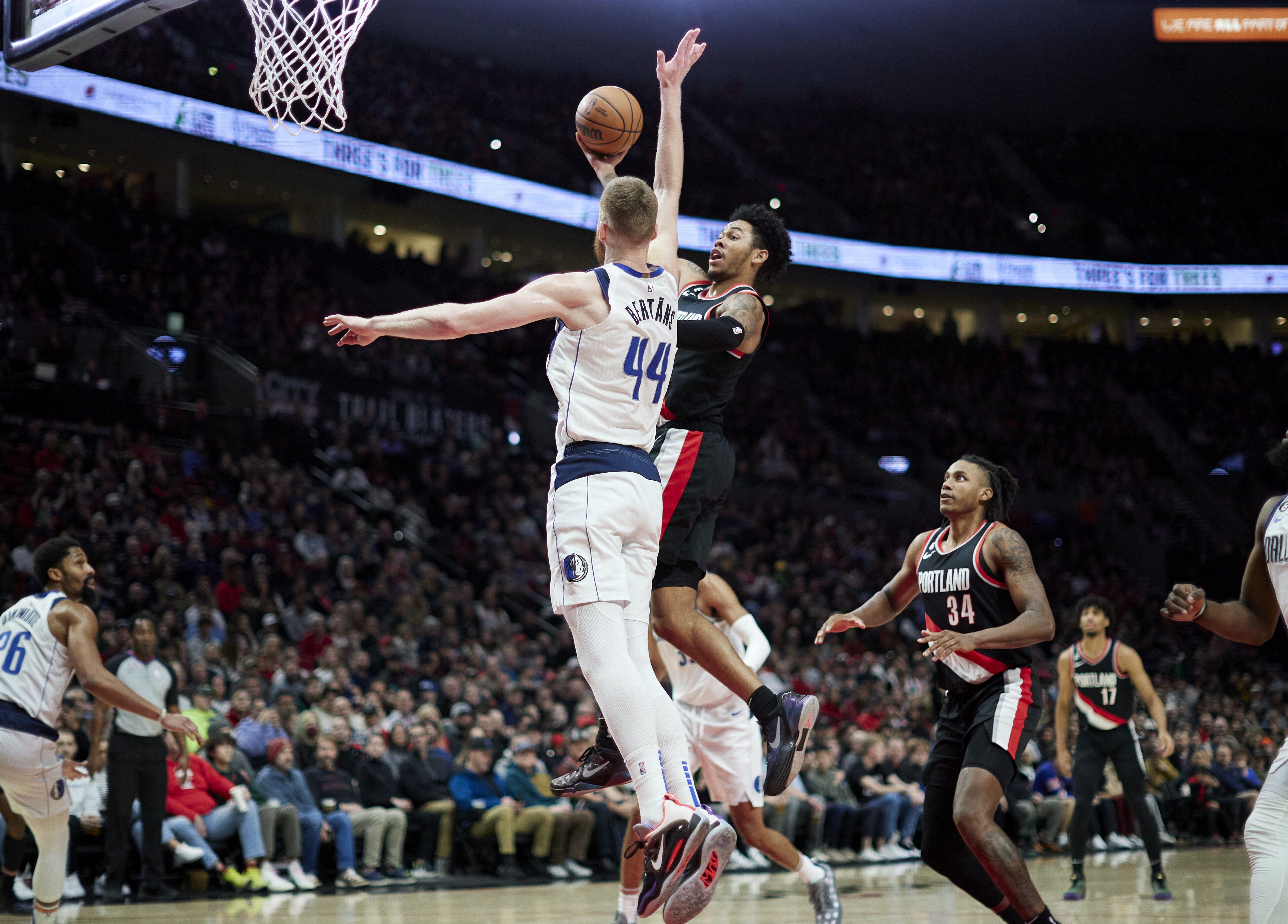 Portland Trail Blazers guard Anfernee Simons, center right, shoots over Dallas Mavericks forward Davis Bertans (44) during the second half of an NBA basketball game in Portland, Ore., Sunday, Jan. 15, 2023. (AP Photo/Craig Mitchelldyer)