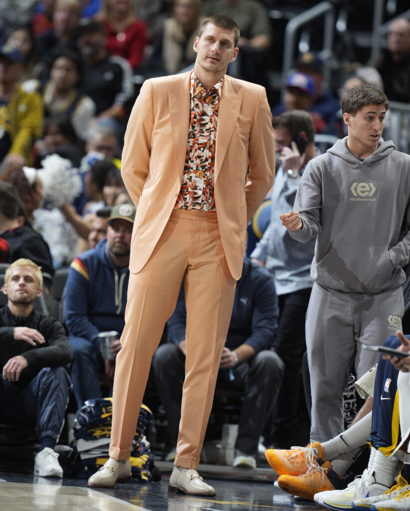 Denver Nuggets center Nikola Jokic, who sat out the game, watches during the second half of the team's NBA basketball game against the Indiana Pacers on Friday, Jan. 20, 2023, in Denver. (AP Photo/David Zalubowski)