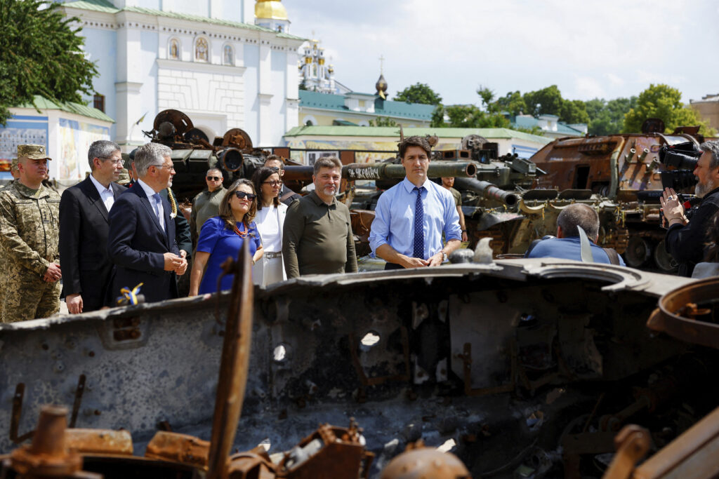 Canadian Prime Minister Justin Trudeau, accompanied by Canada's Minister of Finance Chrystia Freeland, visits an exhibition of destroyed vehicles, in Kyiv, Ukraine, Saturday June 10, 2023. (Valentyn Ogirenko/Pool via AP)