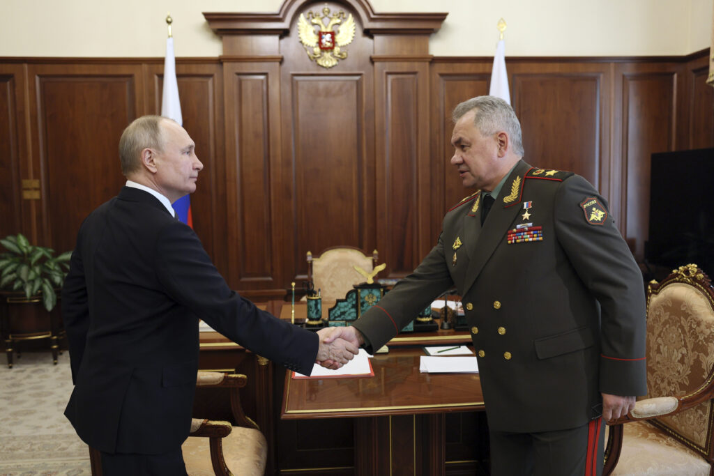 Russian President Vladimir Putin, left, and Russian Defence Minister Sergey Shoigu shake hands during their meeting at the Kremlin in Moscow, Russia, Monday, April 17, 2023. (Gavriil Grigorov, Sputnik, Kremlin Pool Photo via AP)
