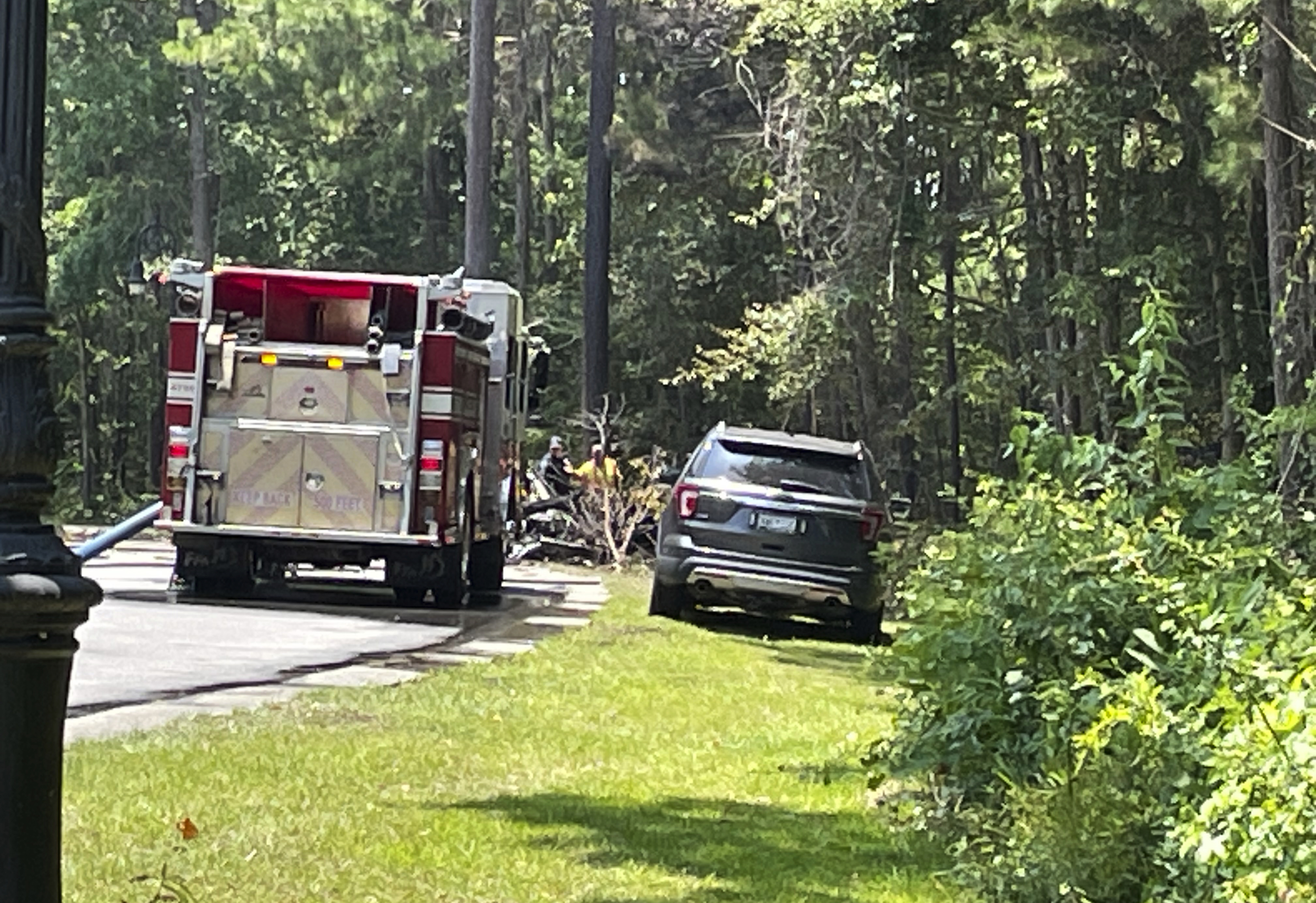 Emergency personnel respond to a single-engine plane crash in the area of Barefoot Landing, in North Myrtle Beach, S.C., Sunday, July 2, 2023. (Terri Richardson/The Sun News via AP)