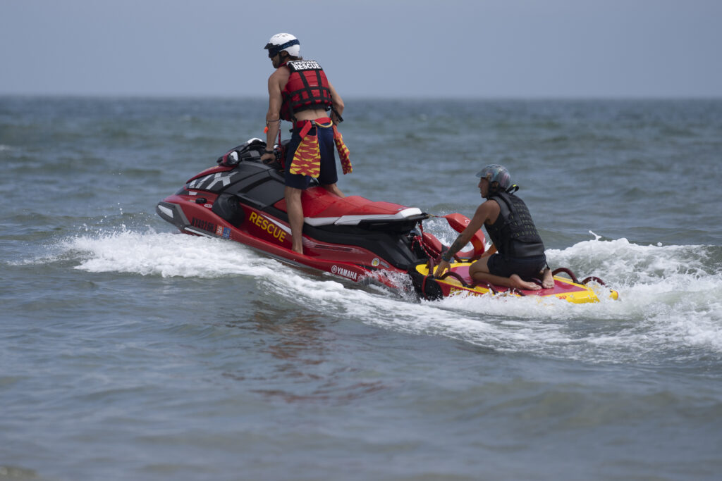 Lifeguards ride a jet ski during a shark patrol run at Jones Beach State Park, Thursday, July 6, 2023, in Wantagh, N.Y. (AP Photo/John Minchillo)