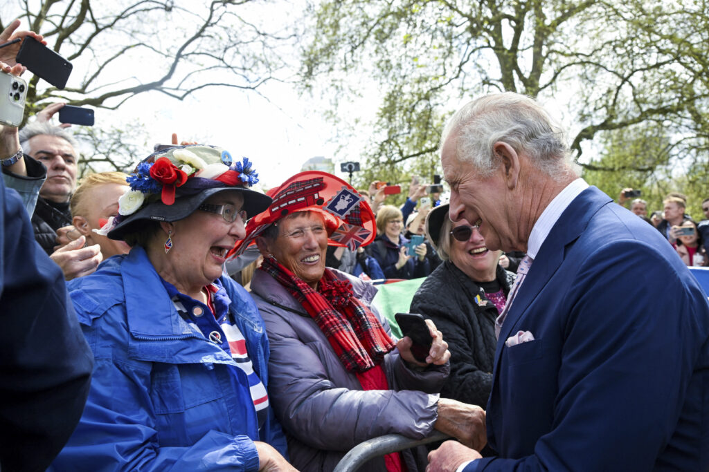 Britain's King Charles III greets well-wishers outside Buckingham Palace, in London, Friday, May 5, 2023 a day before his coronation takes place at Westminster Abbey. (Toby Melville, Pool via AP)