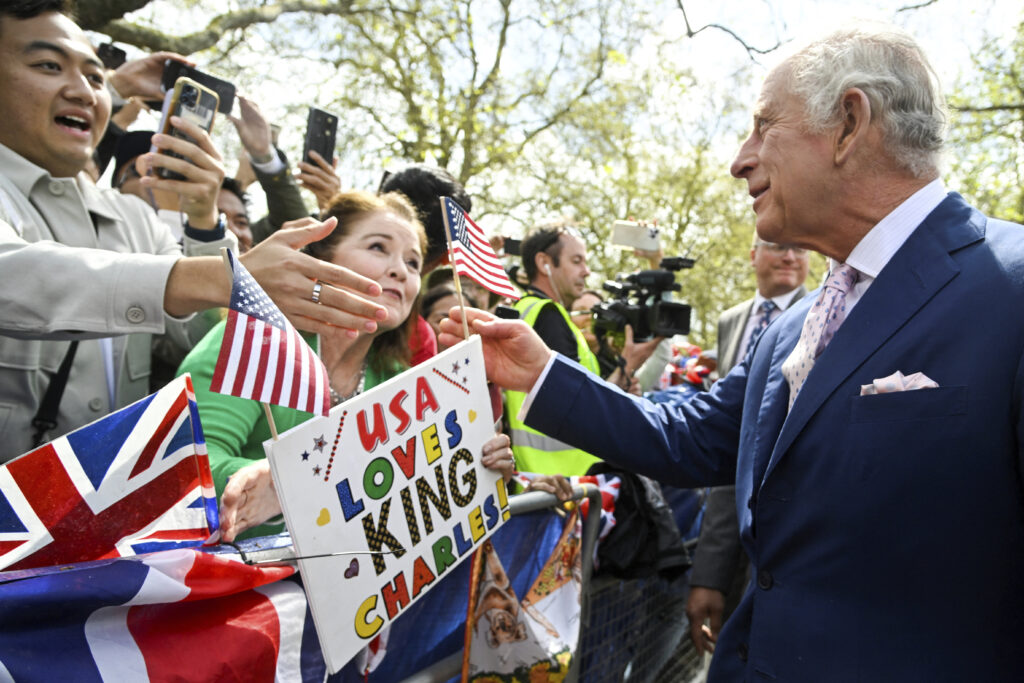 Britain's King Charles III greets well-wishers outside Buckingham Palace, in London, Friday, May 5, 2023 a day before his coronation takes place at Westminster Abbey. (Toby Melville, Pool via AP)