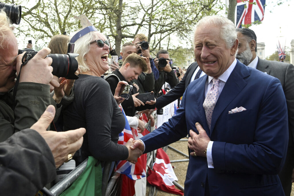 Britain's King Charles III greets well-wishers outside Buckingham Palace, in London, Friday, May 5, 2023 a day before his coronation takes place at Westminster Abbey. (Toby Melville, Pool via AP)