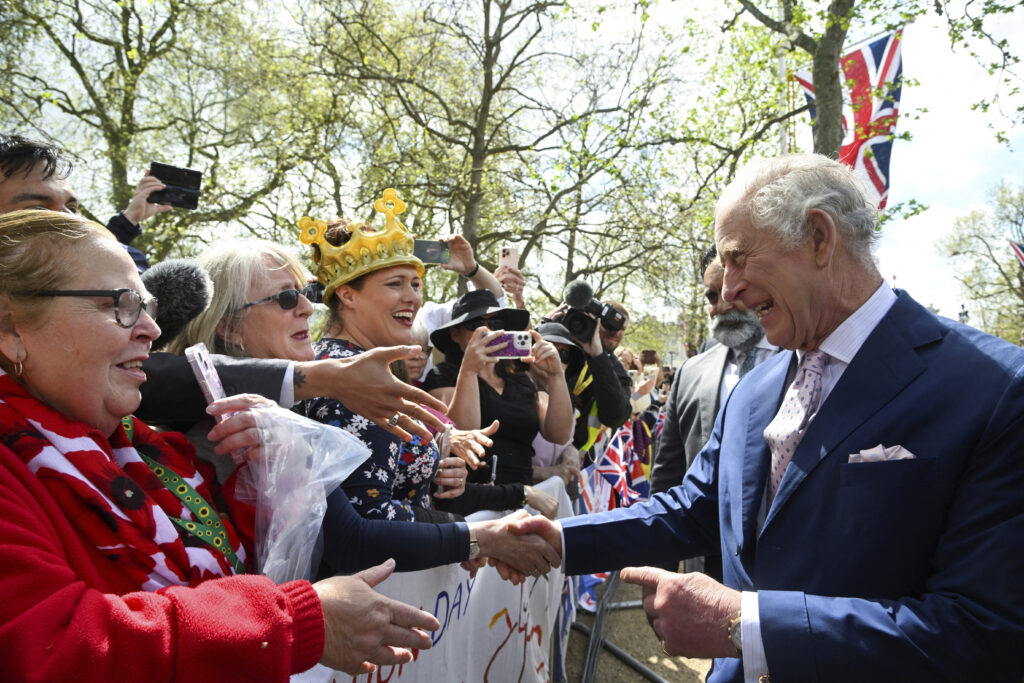 Britain's King Charles III greets well-wishers outside Buckingham Palace, in London, Friday, May 5, 2023 a day before his coronation takes place at Westminster Abbey. (Toby Melville, Pool via AP)