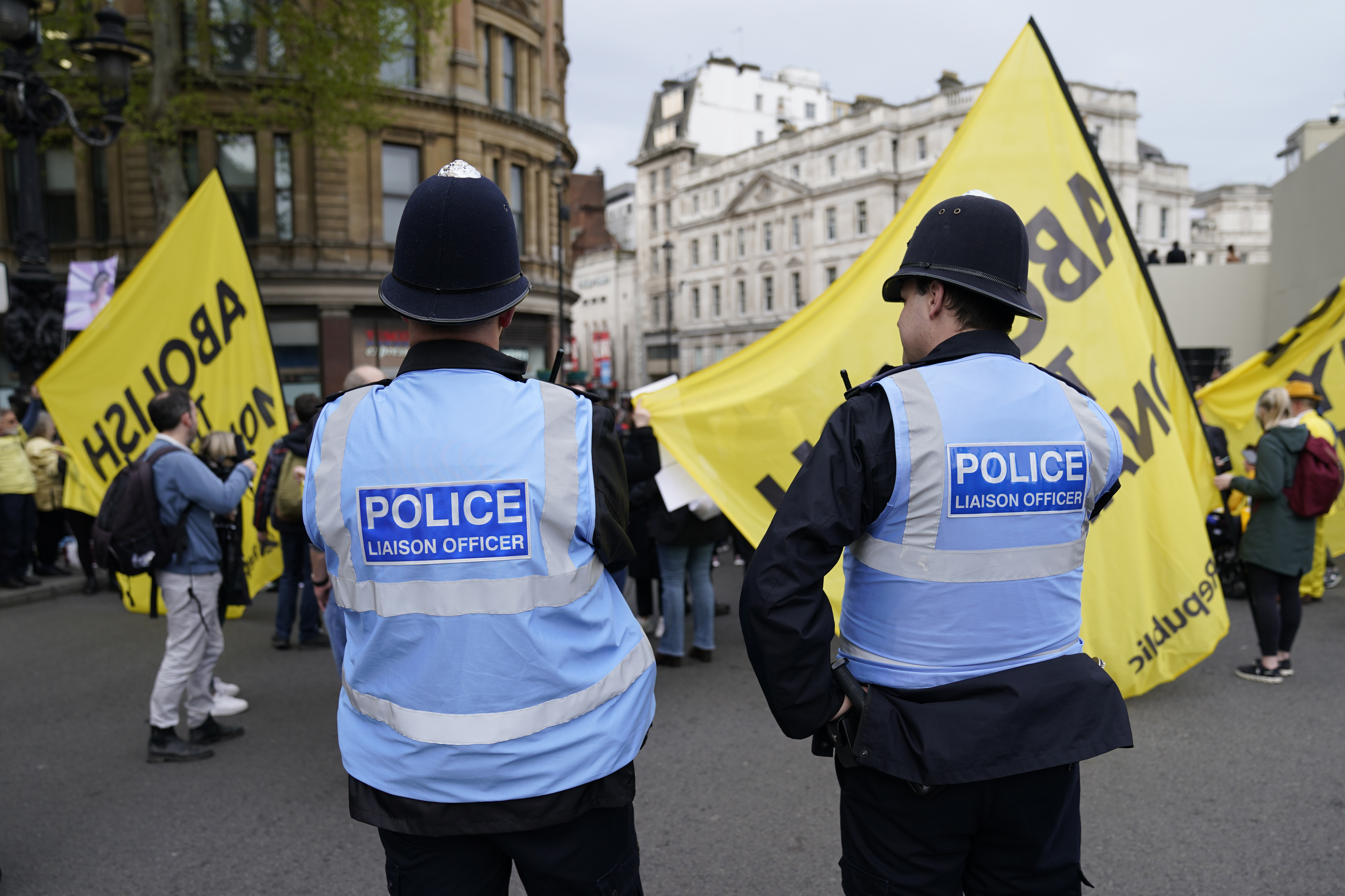 Police look on as they patrol a protest by 'Not My King' demonstrators near the route to be take by Britain's King Charles III coronation procession in London, Saturday, May 6, 2023. (AP Photo/Scott Garfitt)