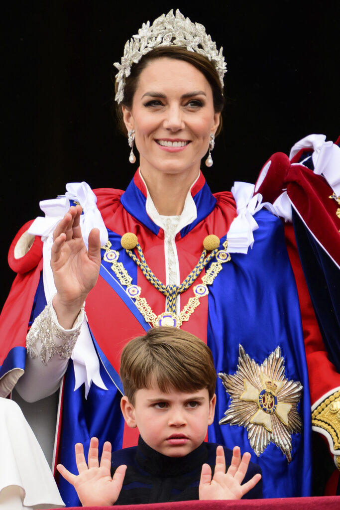 Kate, Princess of Wales, up, stands on the balcony of Buckingham Palace next to Prince Louis, down, during the coronation of Britain's King Charles III, in London, Saturday, May 6, 2023. (Leon Neal/Pool Photo via AP)